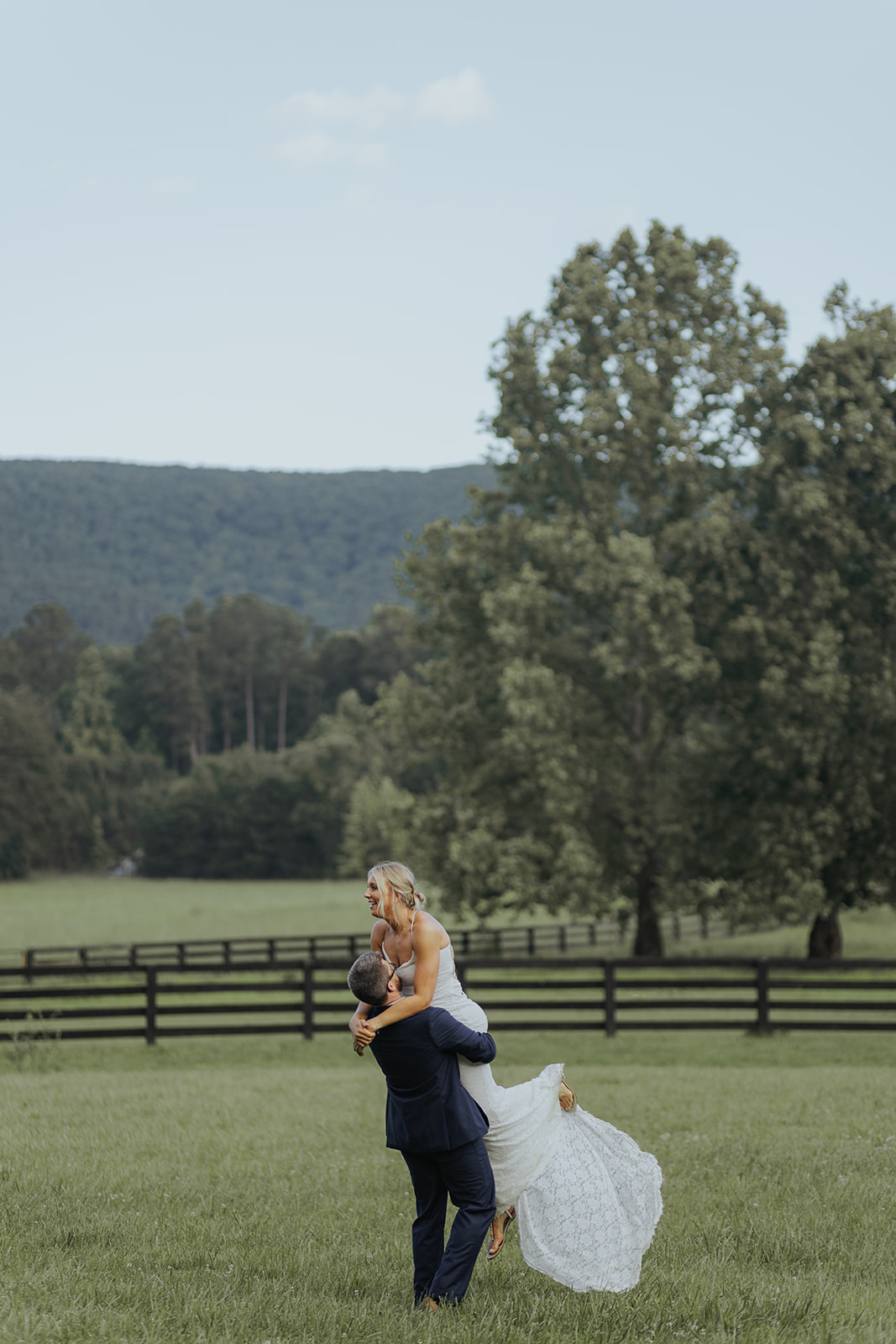 Stunning couple pose together in a wild Georgia field