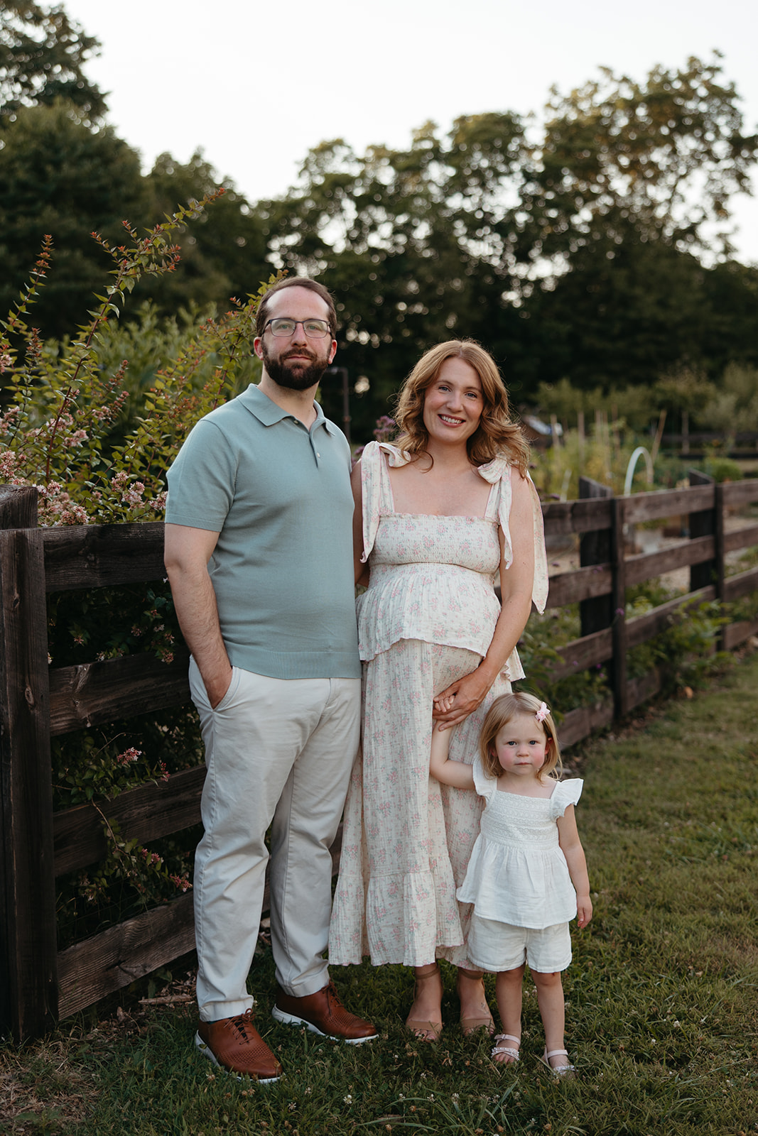 beautiful family poses together for their outdoor maternity photoshoot in Georgia