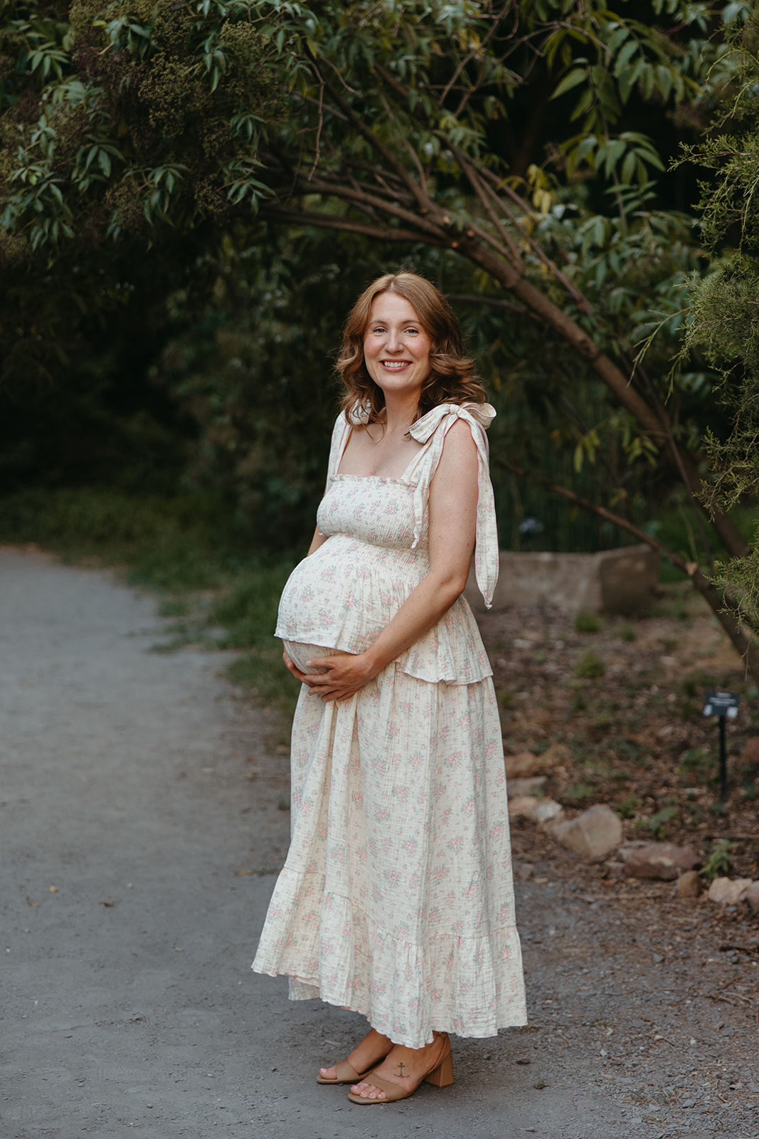 stunning mom poses for a photo during her outdoor Georgia maternity pho