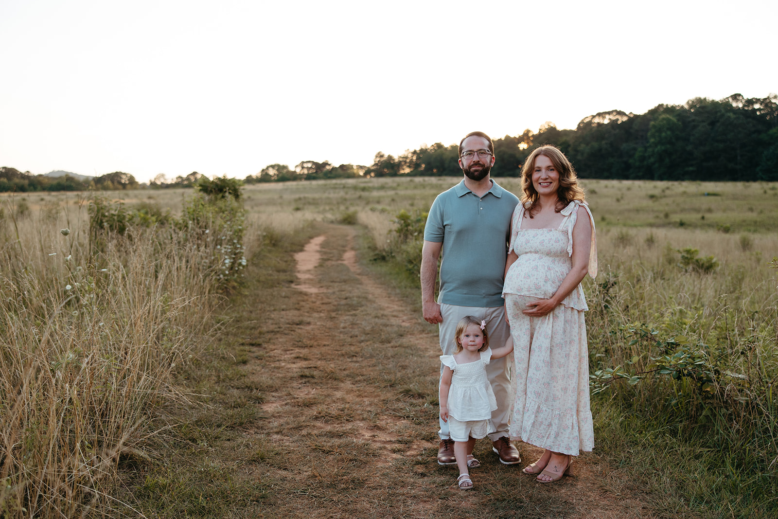 beautiful family poses together in a Georgia field