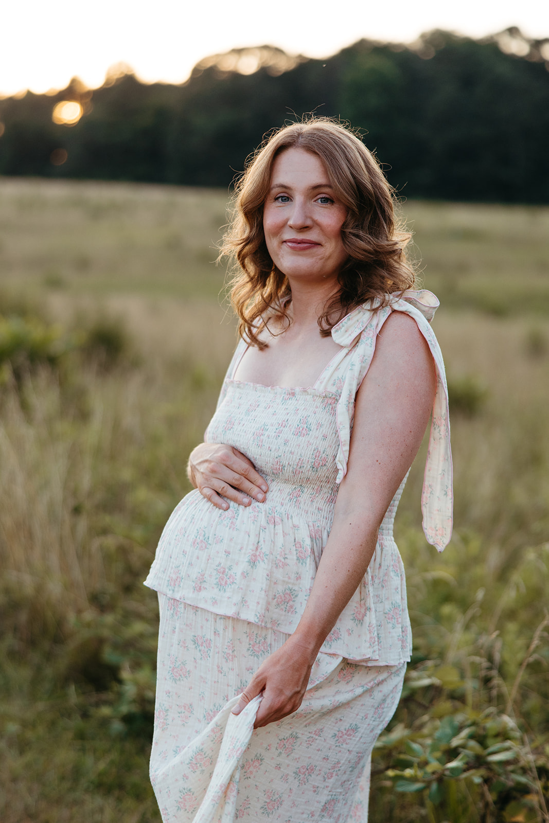 stunning mom poses for a photo during her outdoor Georgia maternity pho