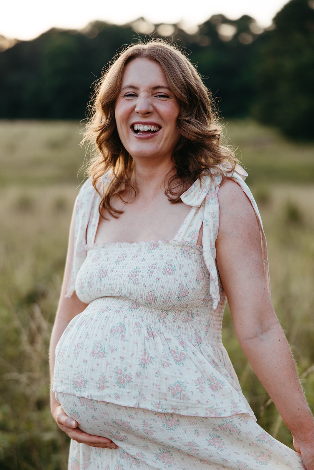 stunning mom poses for a photo during her outdoor Georgia maternity pho