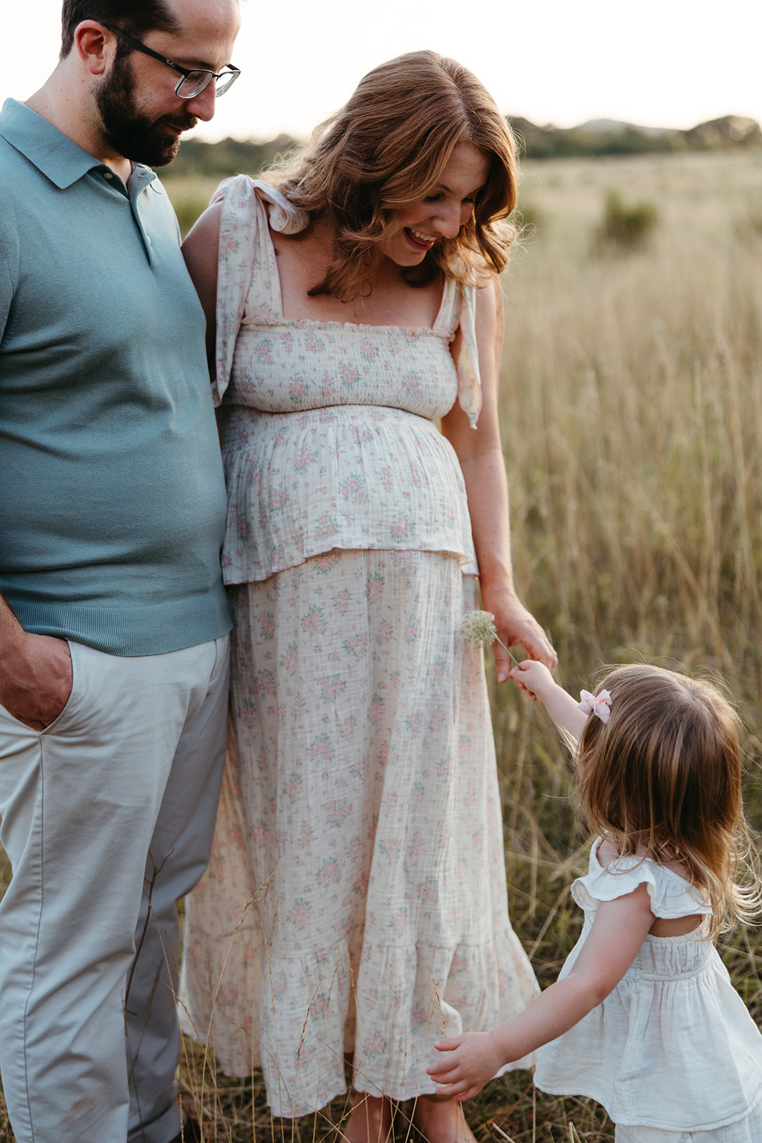 beautiful family poses together in a Georgia field