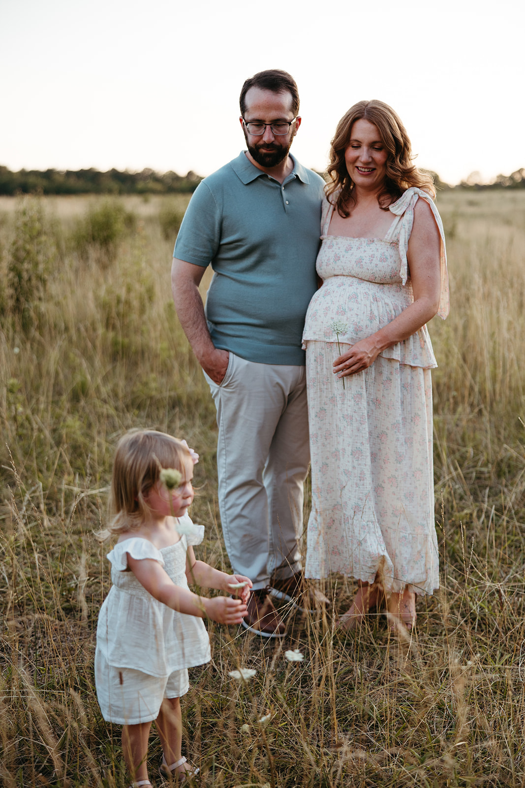 beautiful family poses together for their outdoor maternity photoshoot in Georgia