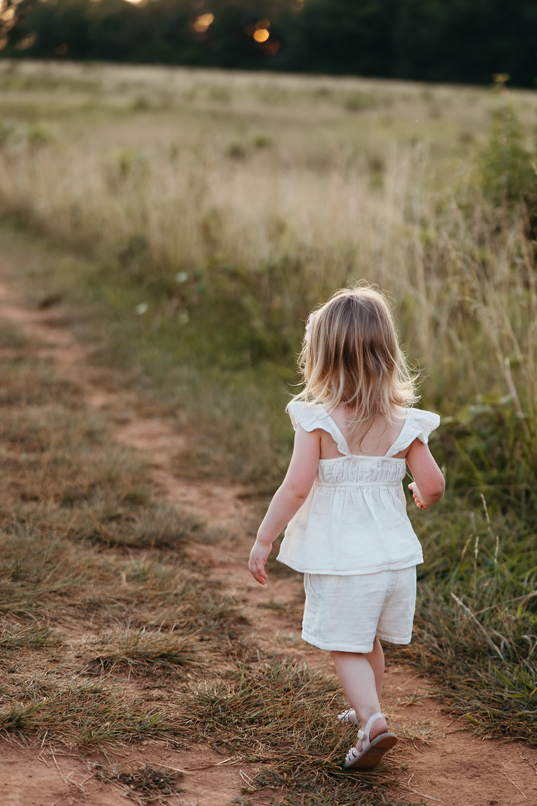 future big sister takes a photo in a Georgia field