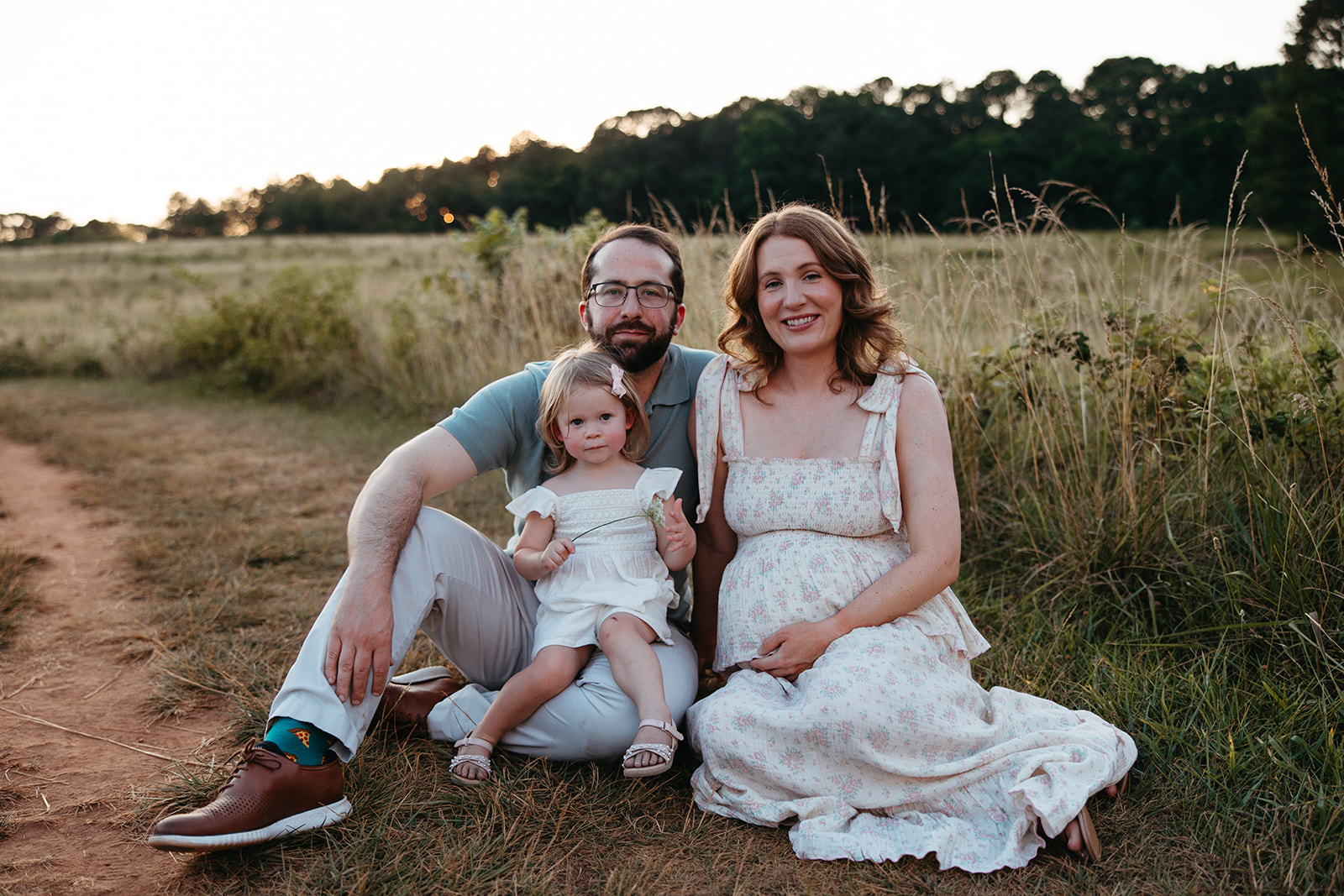 beautiful family poses together in a Georgia field