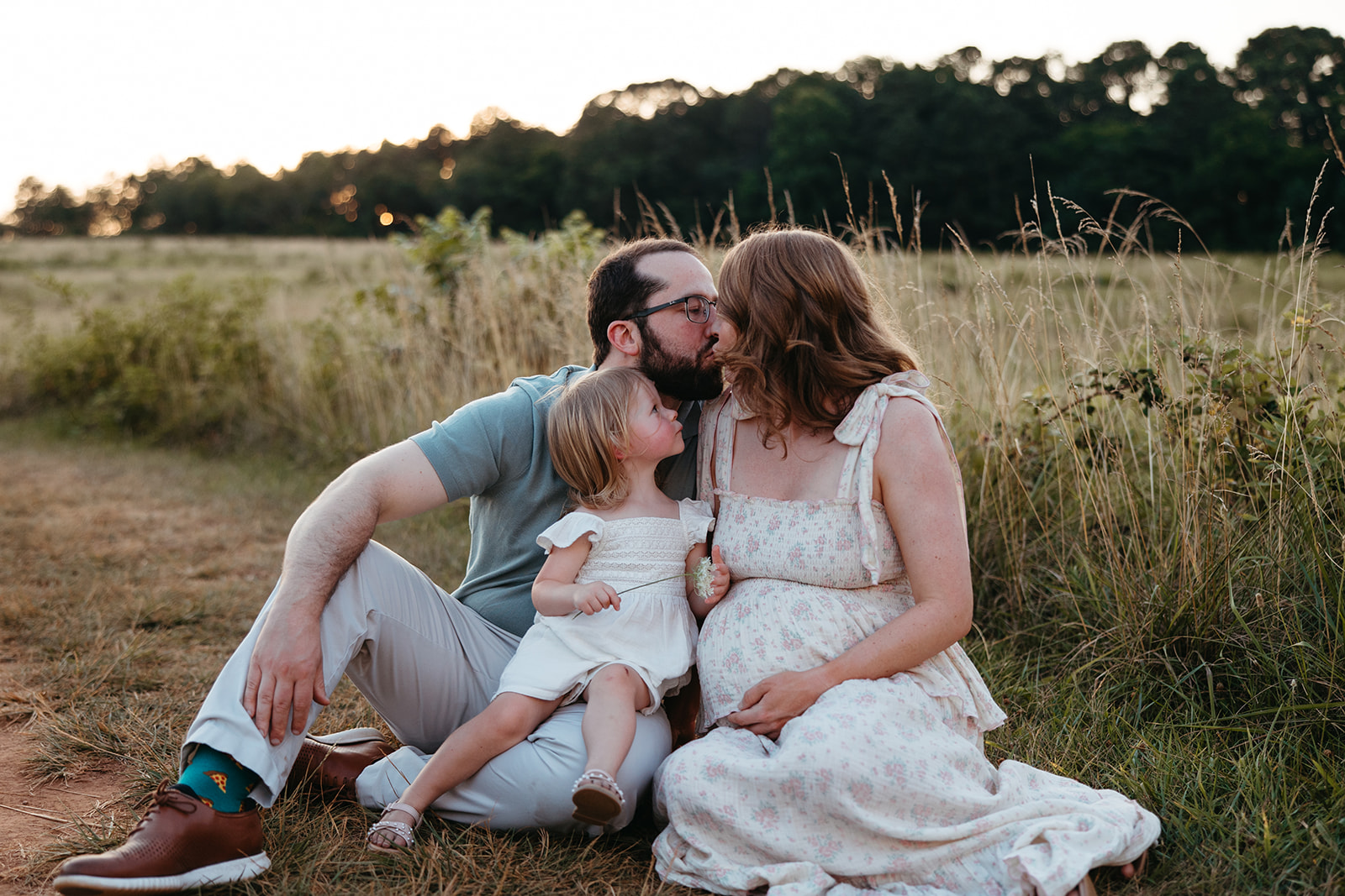 beautiful family poses together in a Georgia field