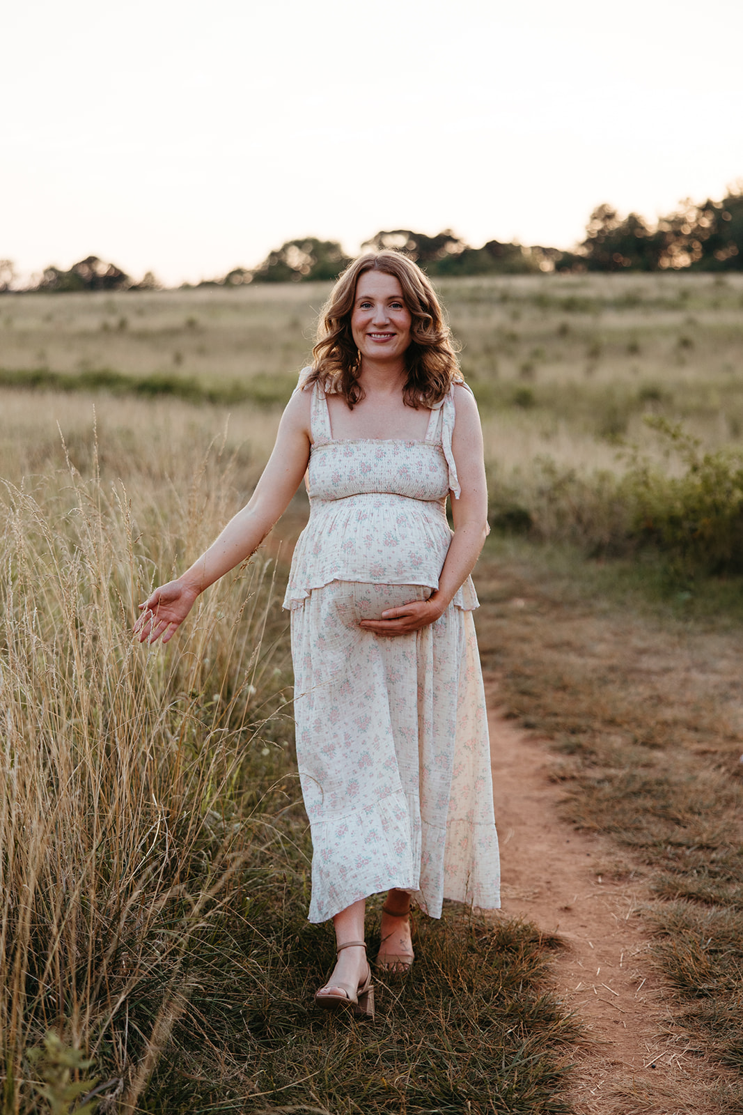 stunning mom poses for a photo during her outdoor Georgia maternity pho