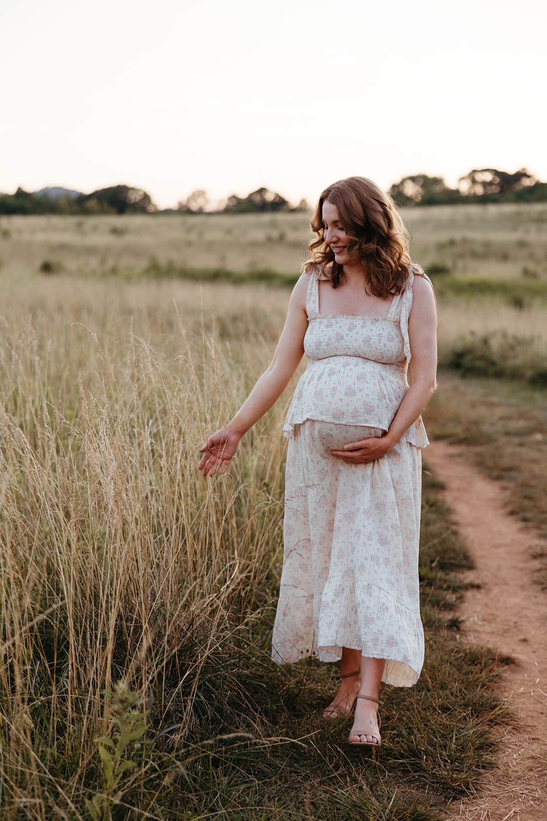 stunning mom poses for a photo during her outdoor Georgia maternity pho