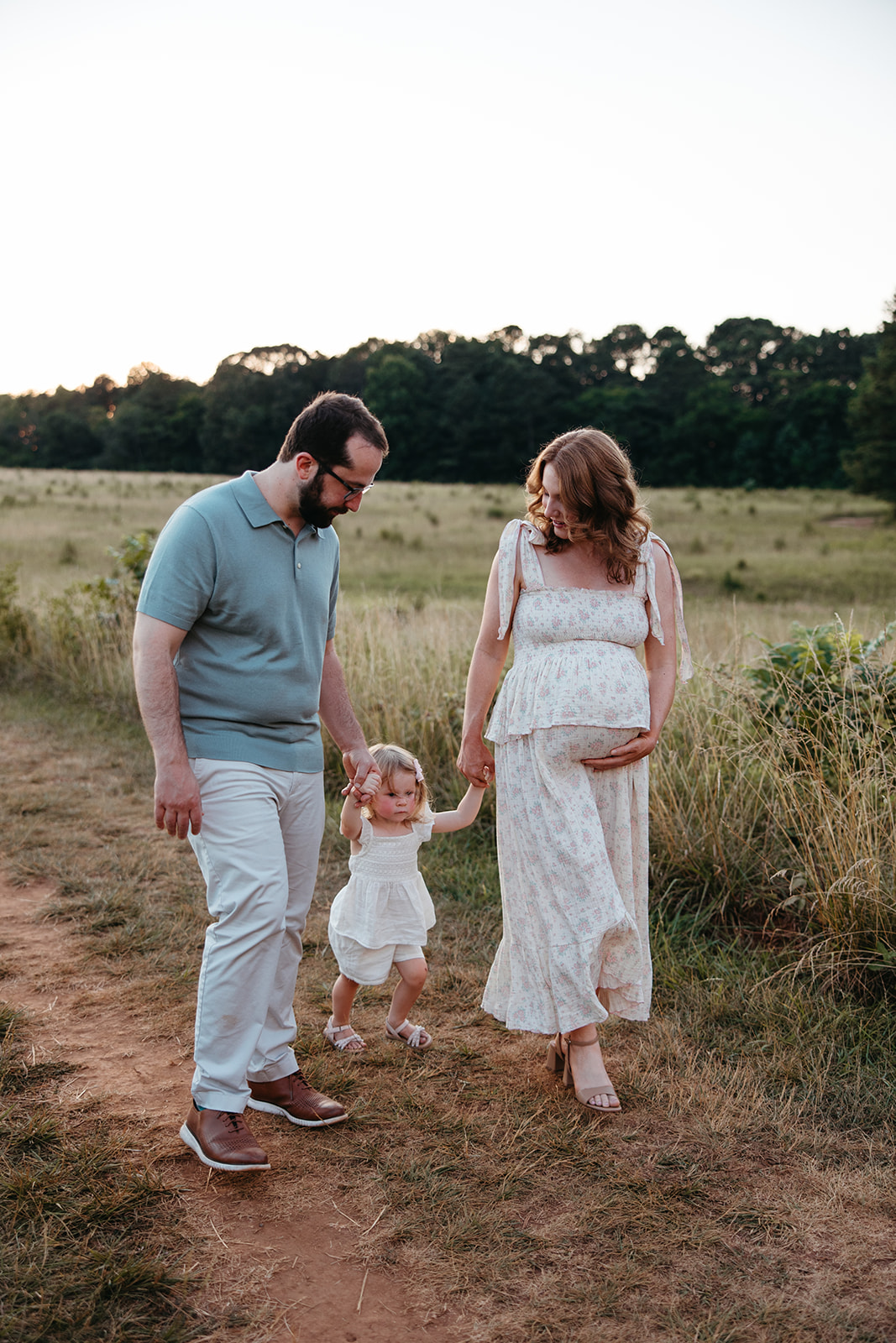 beautiful family poses together in a Georgia field