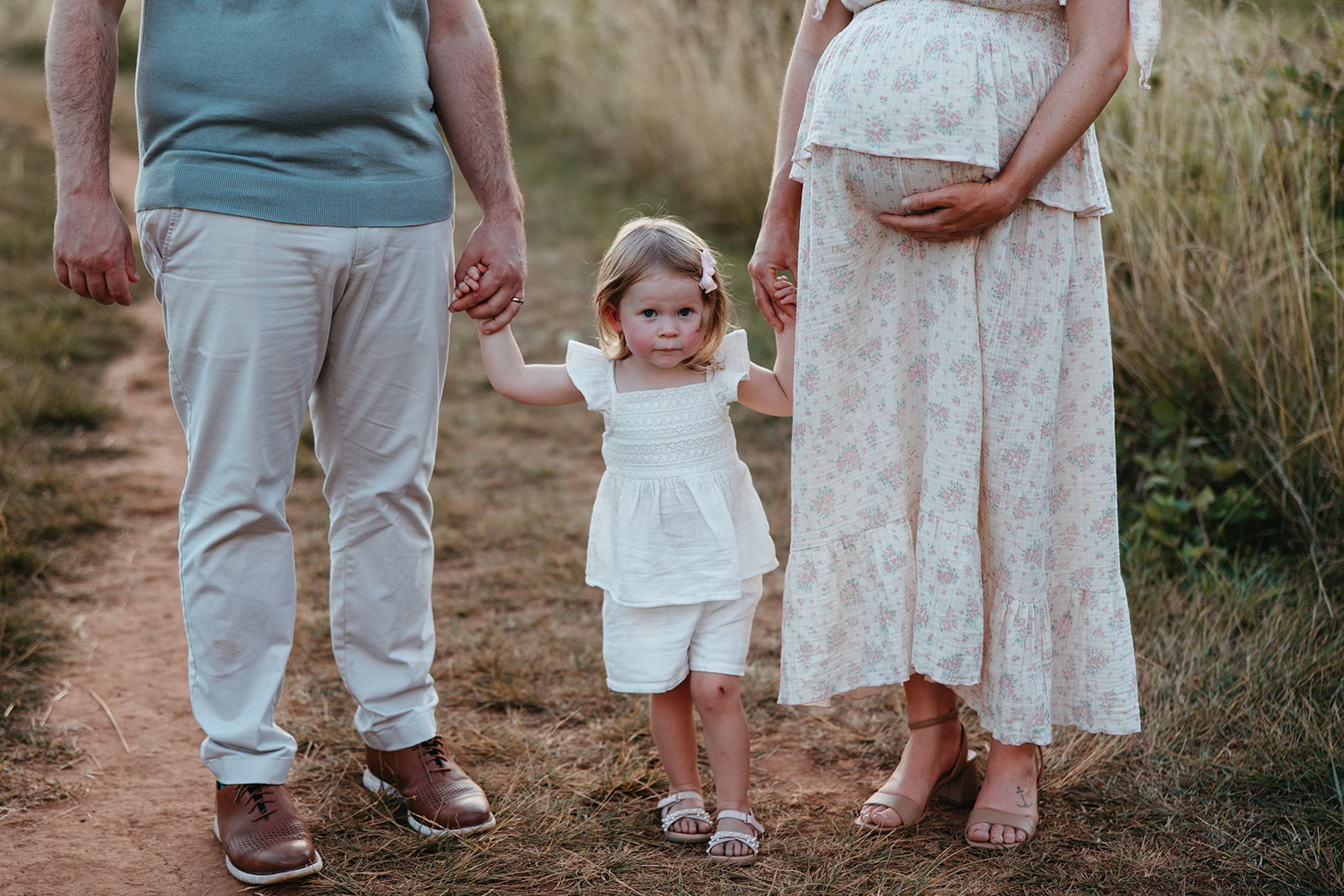 beautiful family poses together for their outdoor maternity photoshoot in Georgia