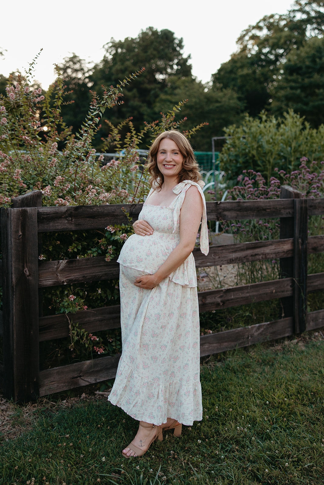 stunning mom poses for a photo during her outdoor Georgia maternity photoshoot