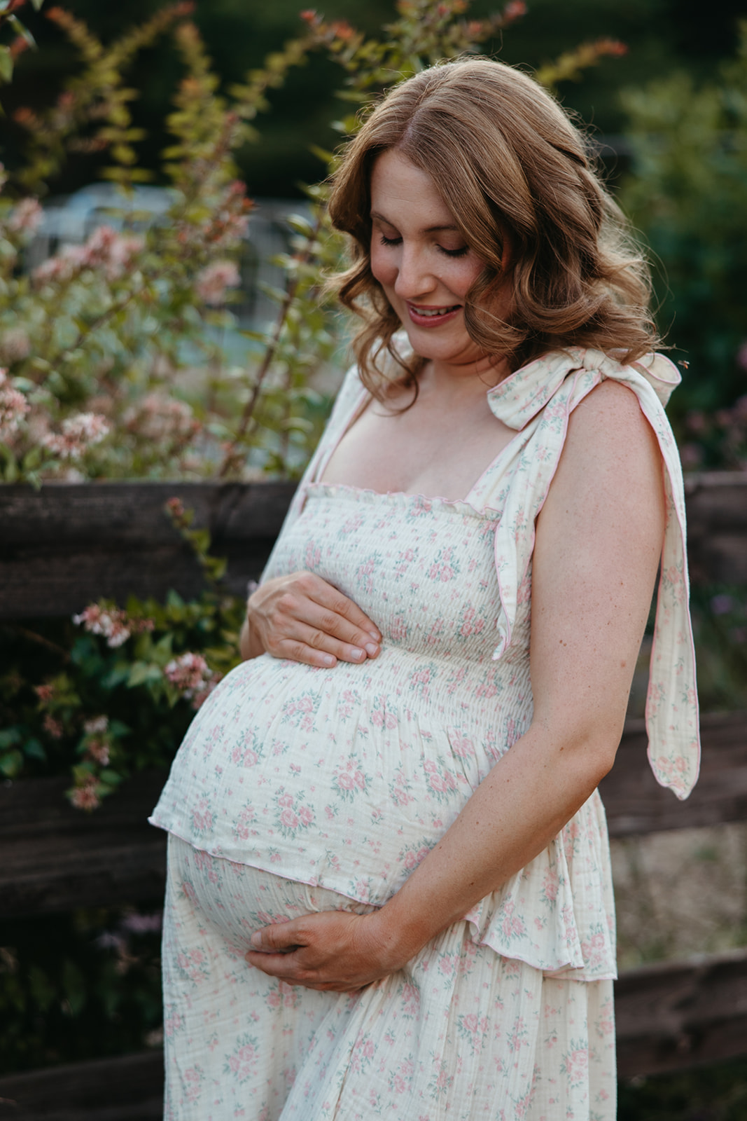 stunning mom poses for a photo during her outdoor Georgia maternity pho