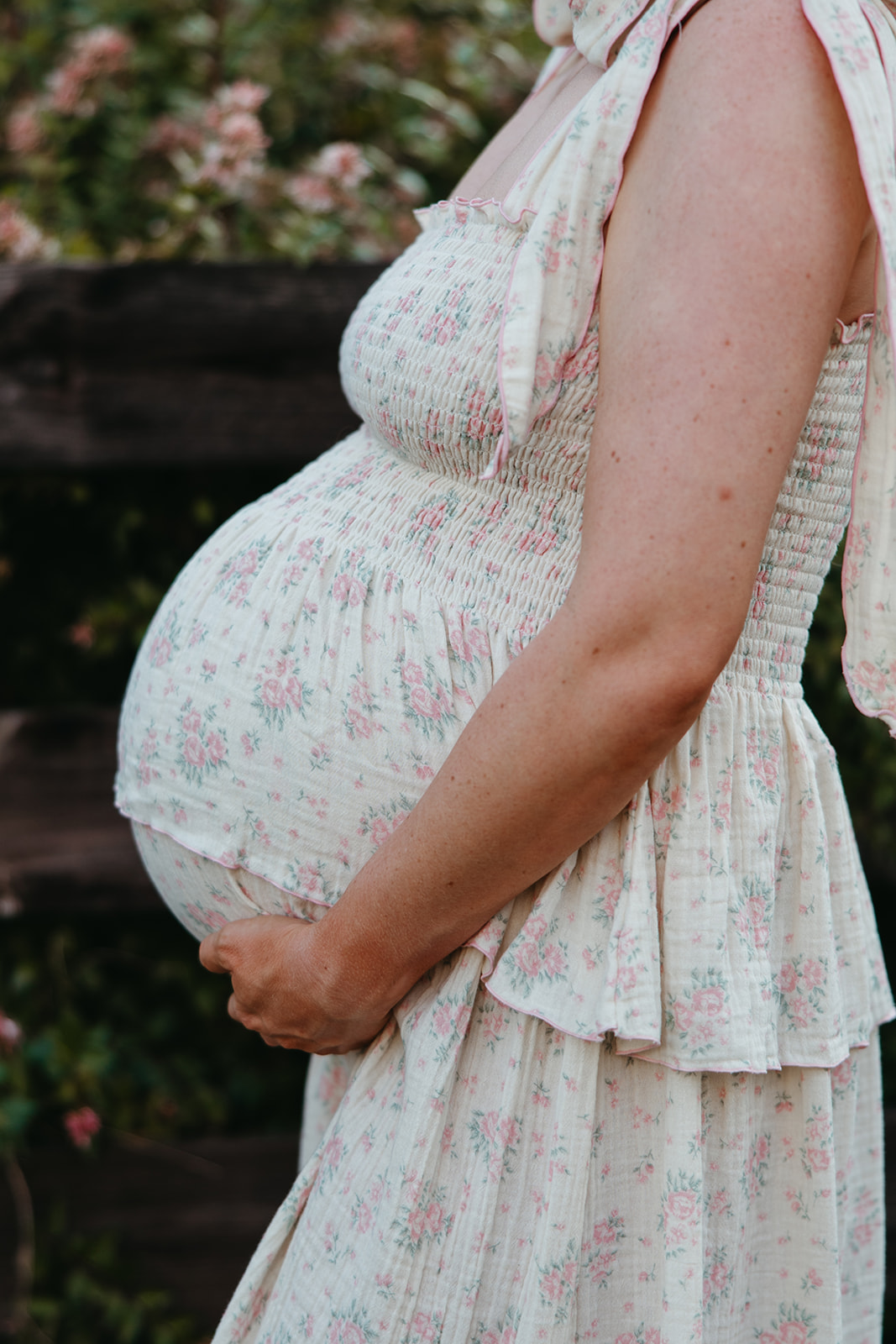 stunning mom poses for a photo during her outdoor Georgia maternity pho