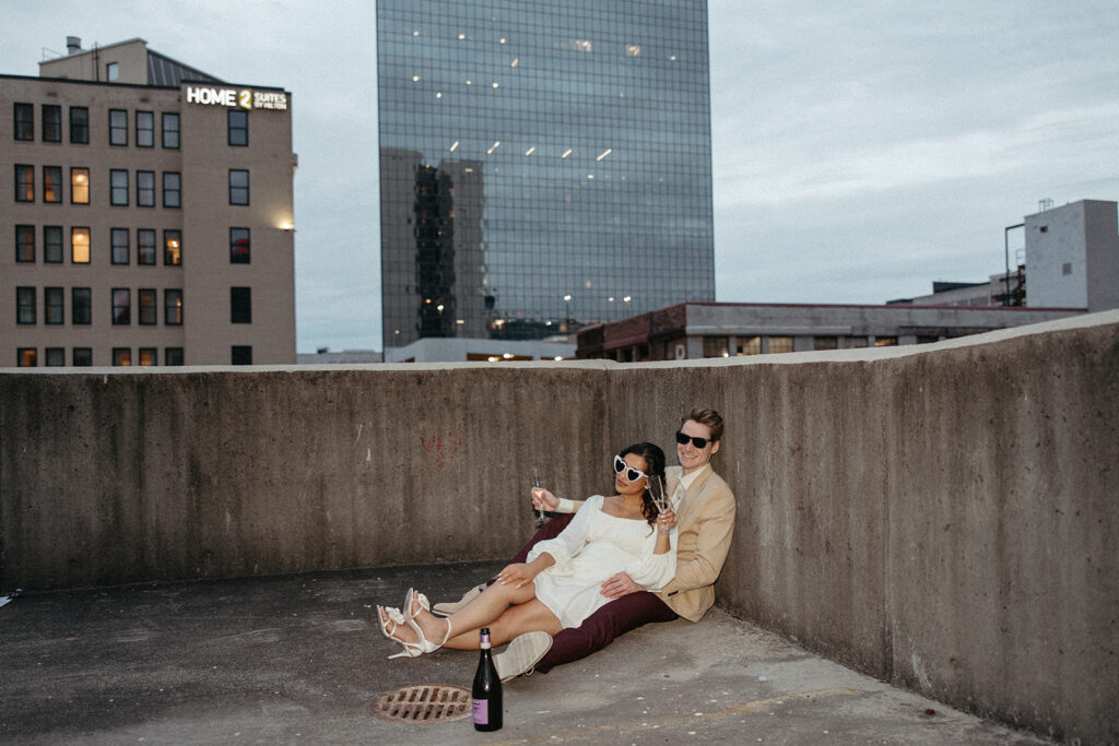 stunning couple pose together on an Atlanta parking garage during their Georgia engagement photoshoot