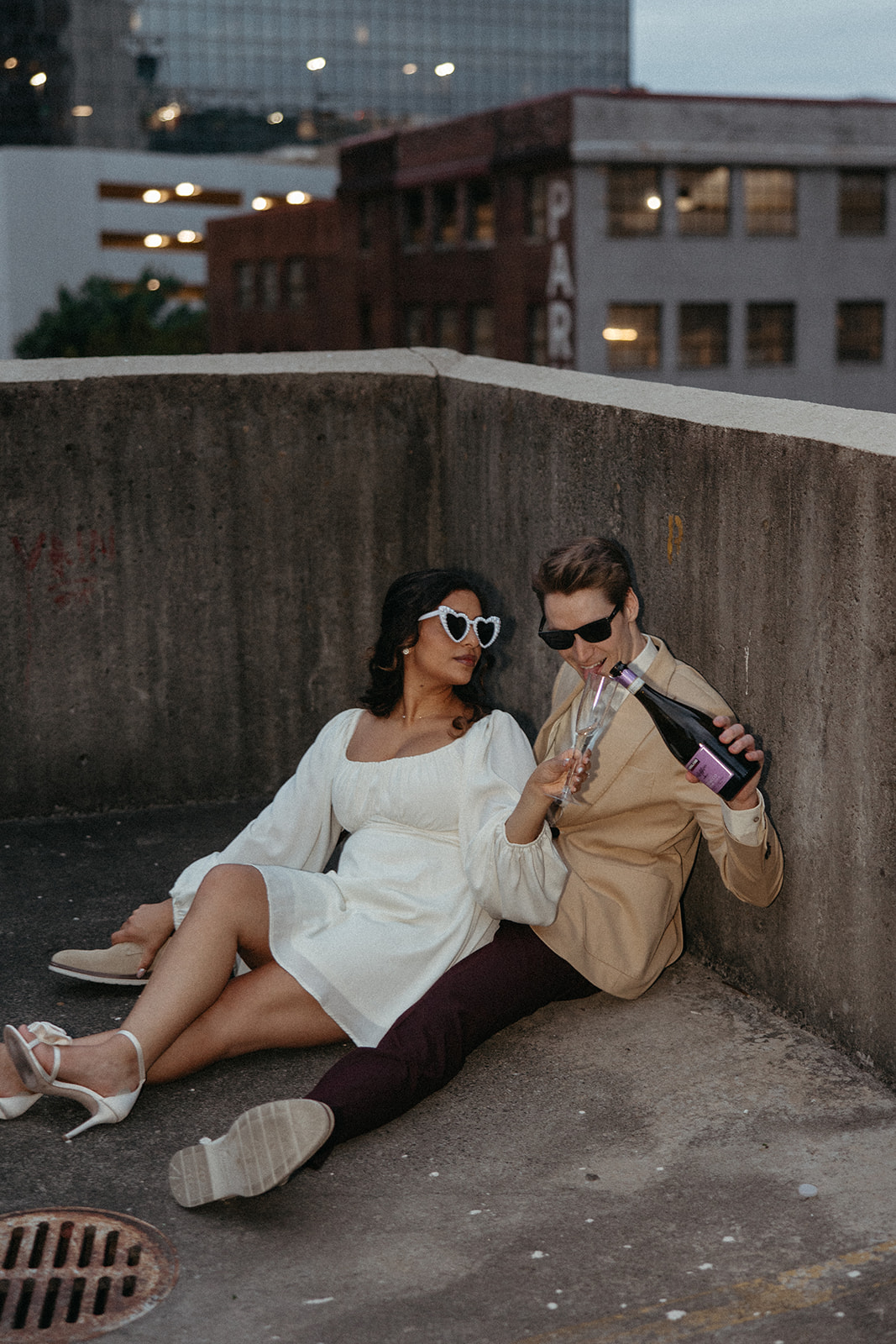 stunning couple pose together on an Atlanta parking garage during their Georgia engagement photoshoot