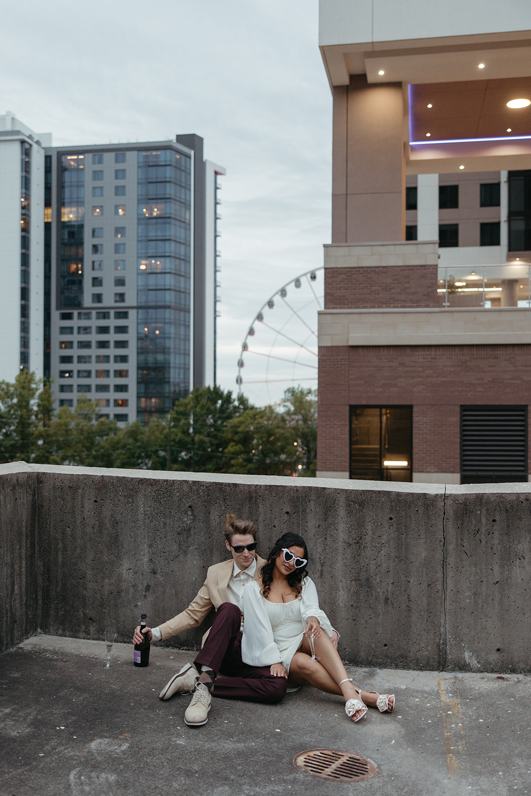 stunning couple pose together on an Atlanta parking garage during their Georgia engagement photoshoot