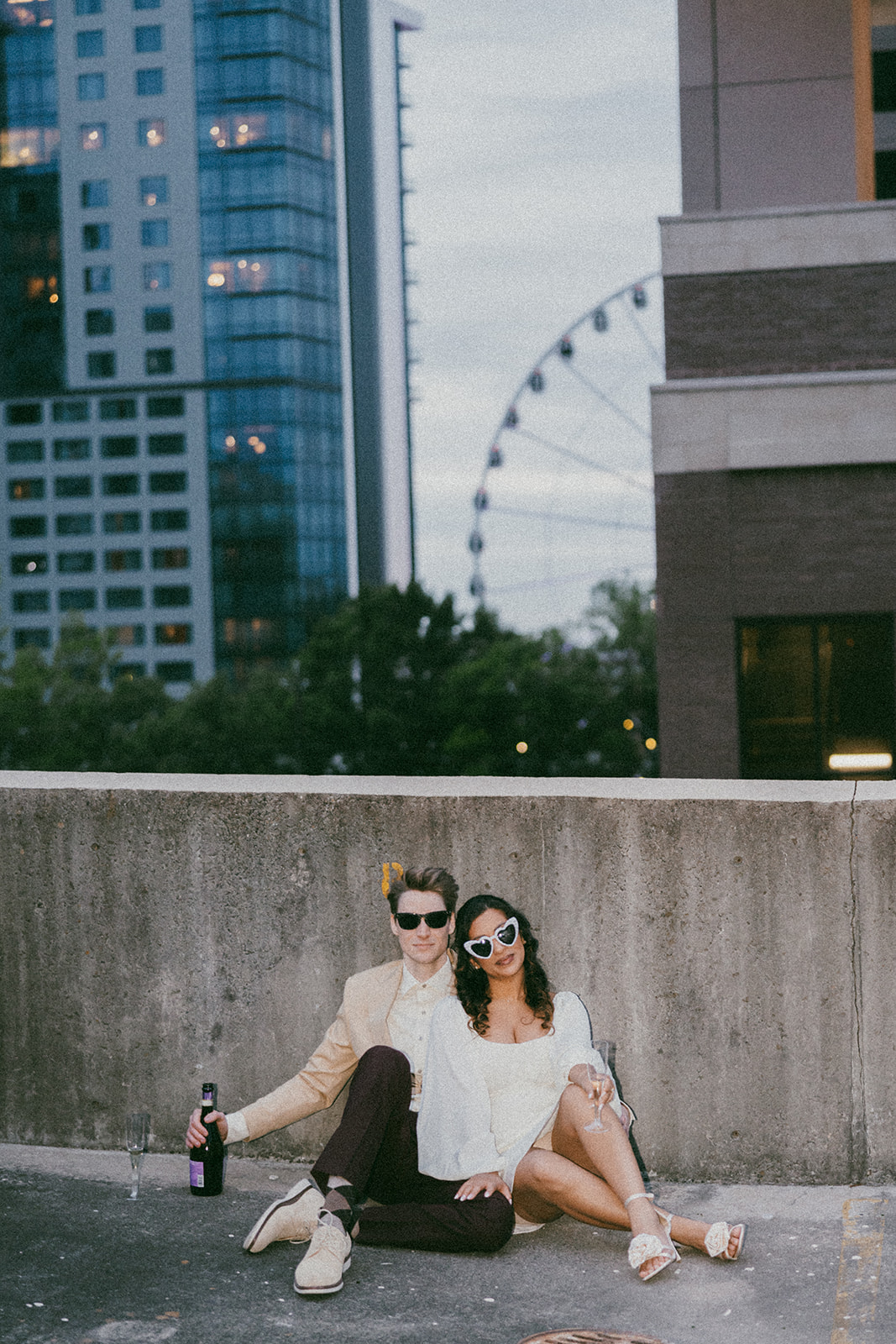 stunning couple pose together on an Atlanta parking garage during their Georgia engagement photoshoot