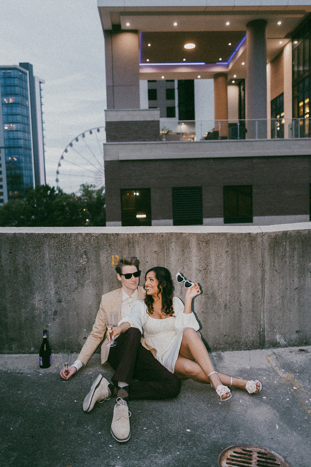 stunning couple pose together on an Atlanta parking garage during their Georgia engagement photoshoot