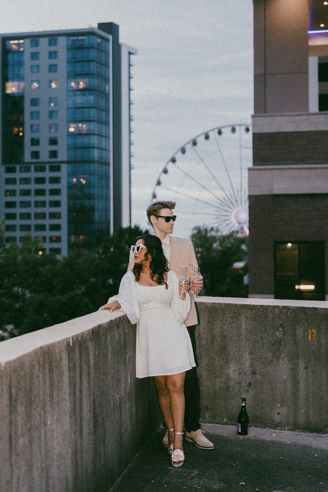 stunning couple pose together on an Atlanta parking garage during their Georgia engagement photoshoot