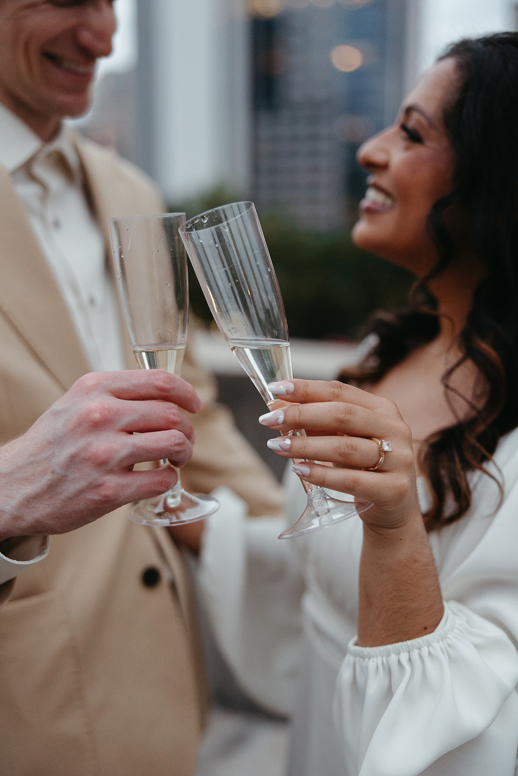 couple pose with glasses of champagne to celebrate their Georgia engagement photos