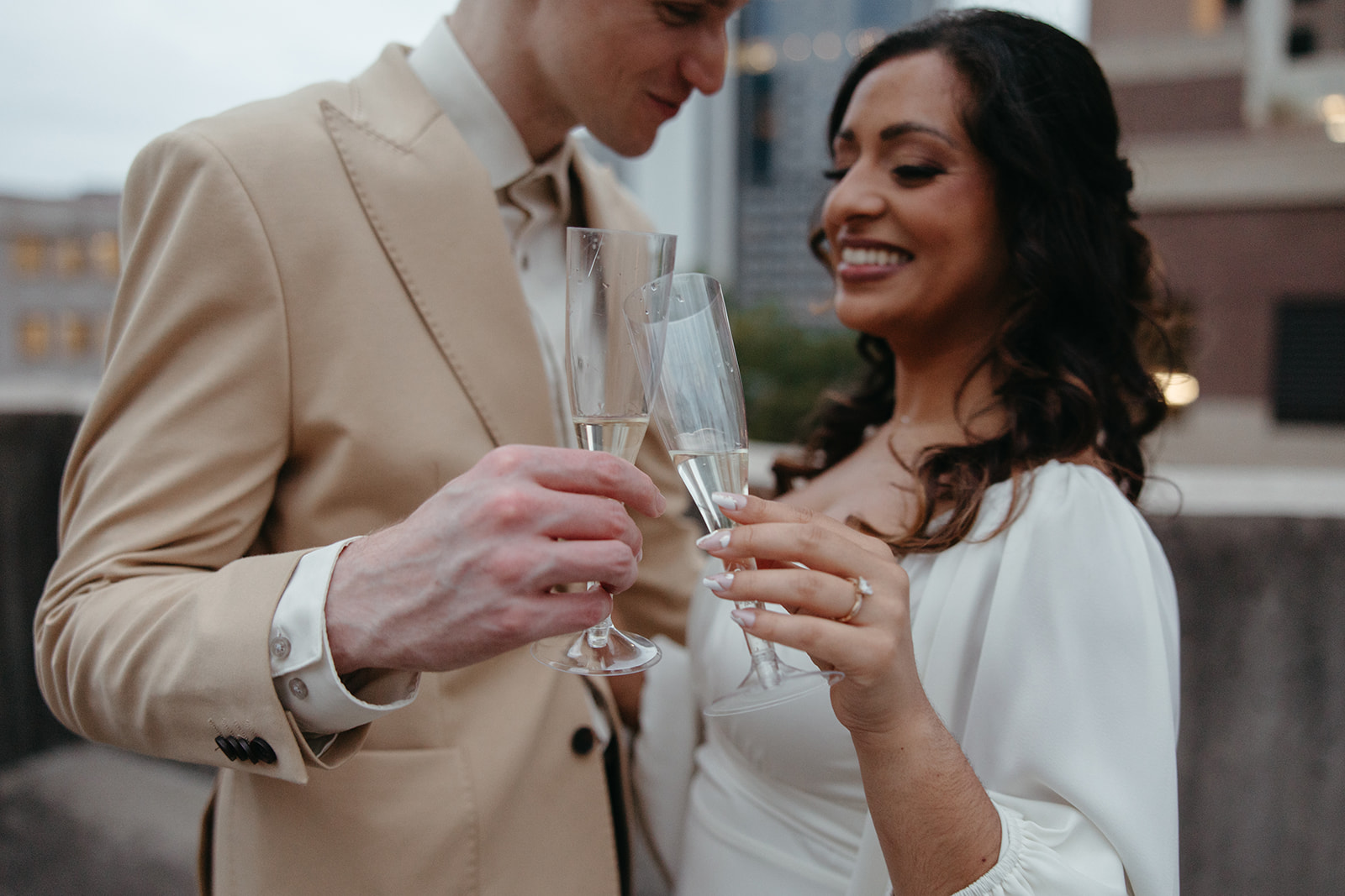 couple pose with glasses of champagne to celebrate their Georgia engagement photos