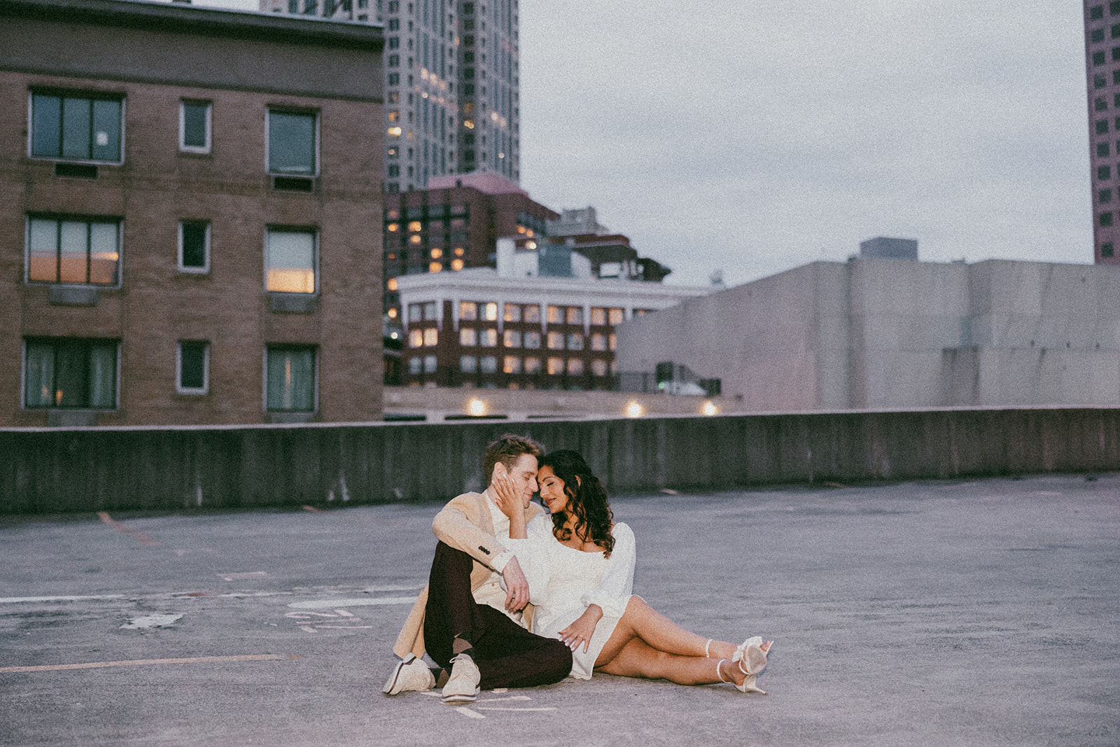 stunning couple pose together on an Atlanta parking garage during their Georgia engagement photoshoot