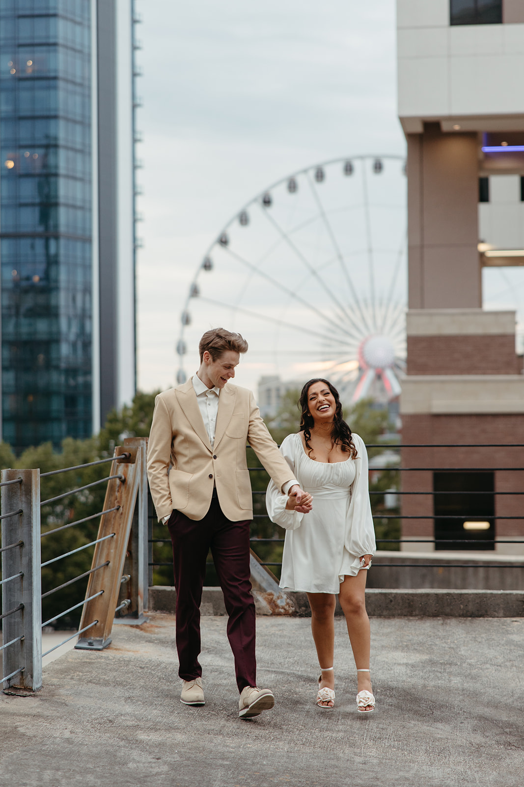 stunning couple pose together on an Atlanta parking garage during their Georgia engagement photoshoot