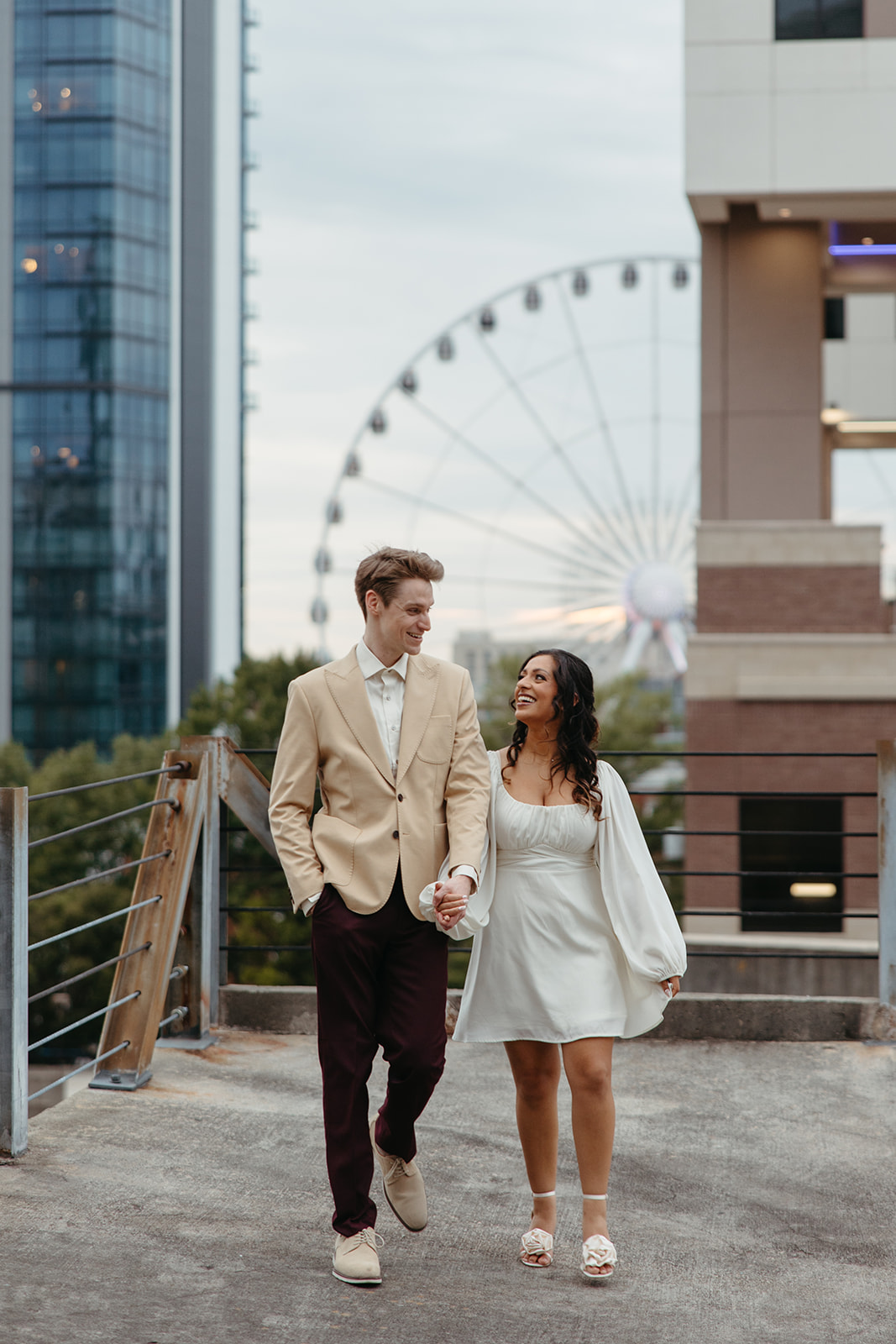 stunning couple pose together on an Atlanta parking garage during their Georgia engagement photoshoot