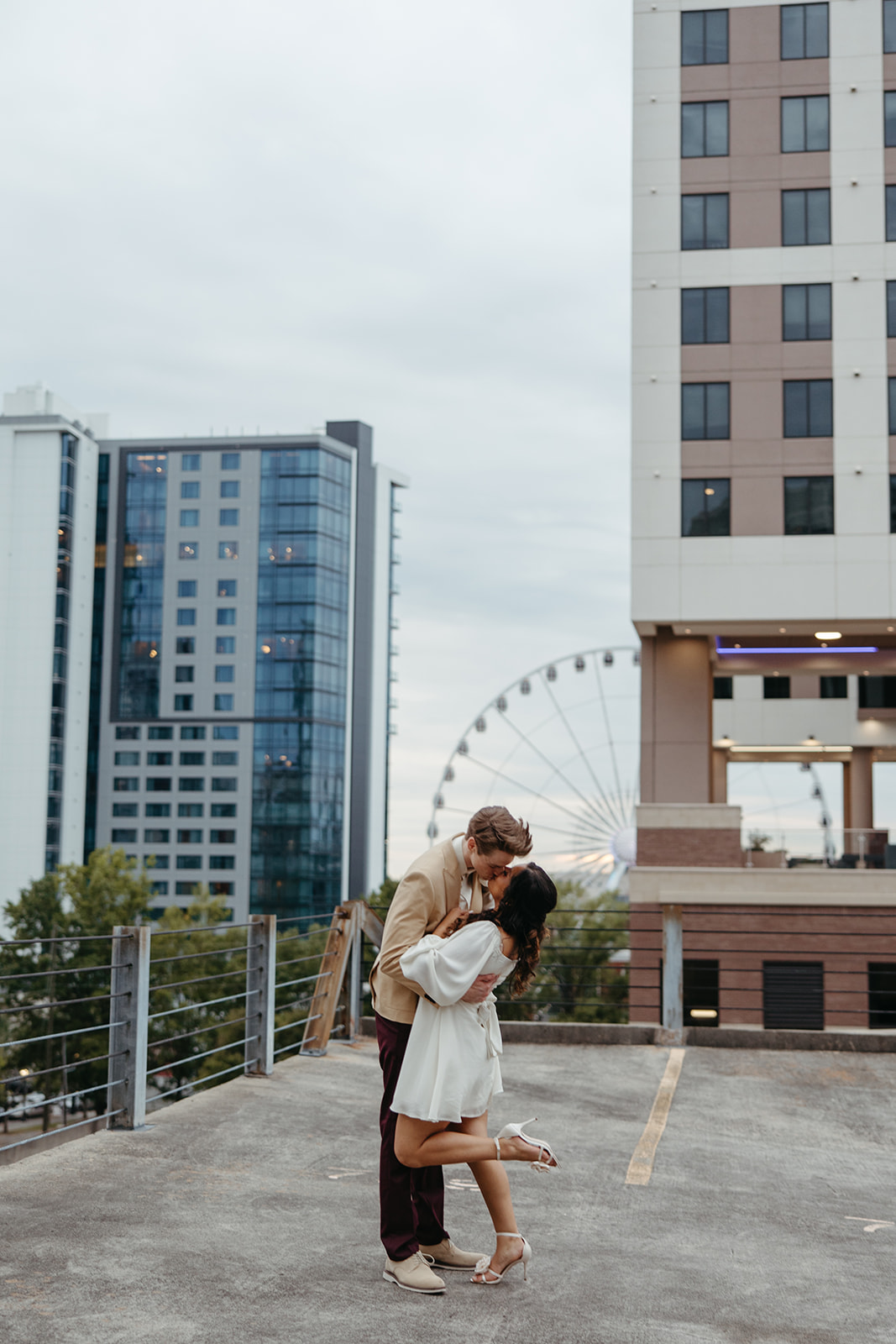 stunning couple pose together on an Atlanta parking garage during their Georgia engagement photoshoot