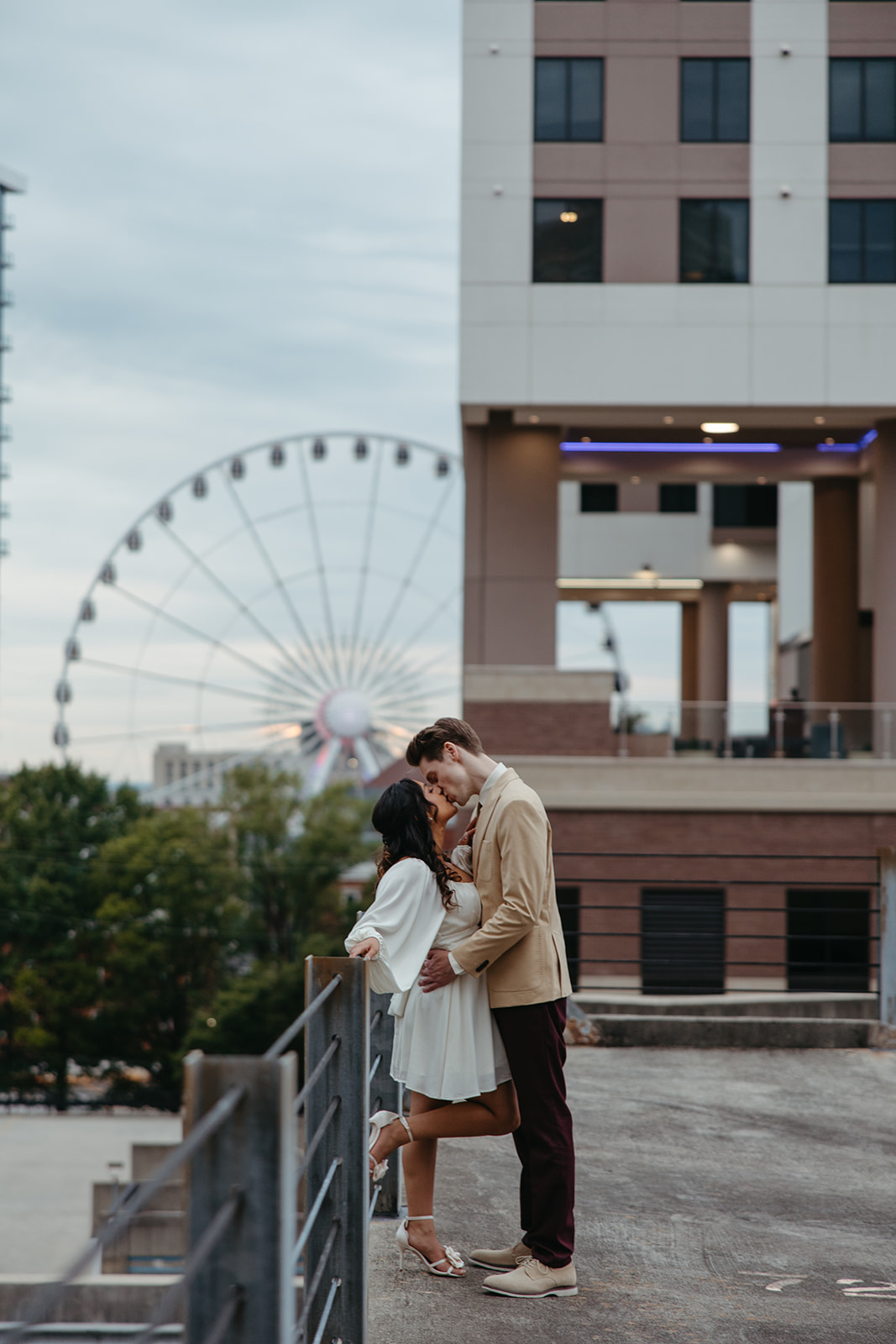 stunning couple pose together on an Atlanta parking garage during their Georgia engagement photoshoot