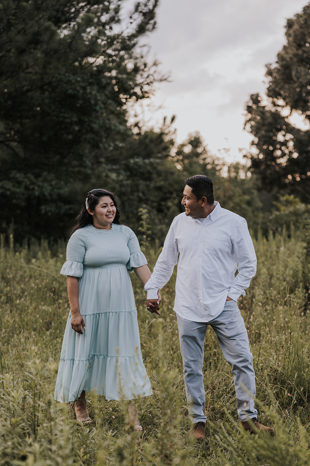 beautiful couple stands in a Georgia field together during their mini session