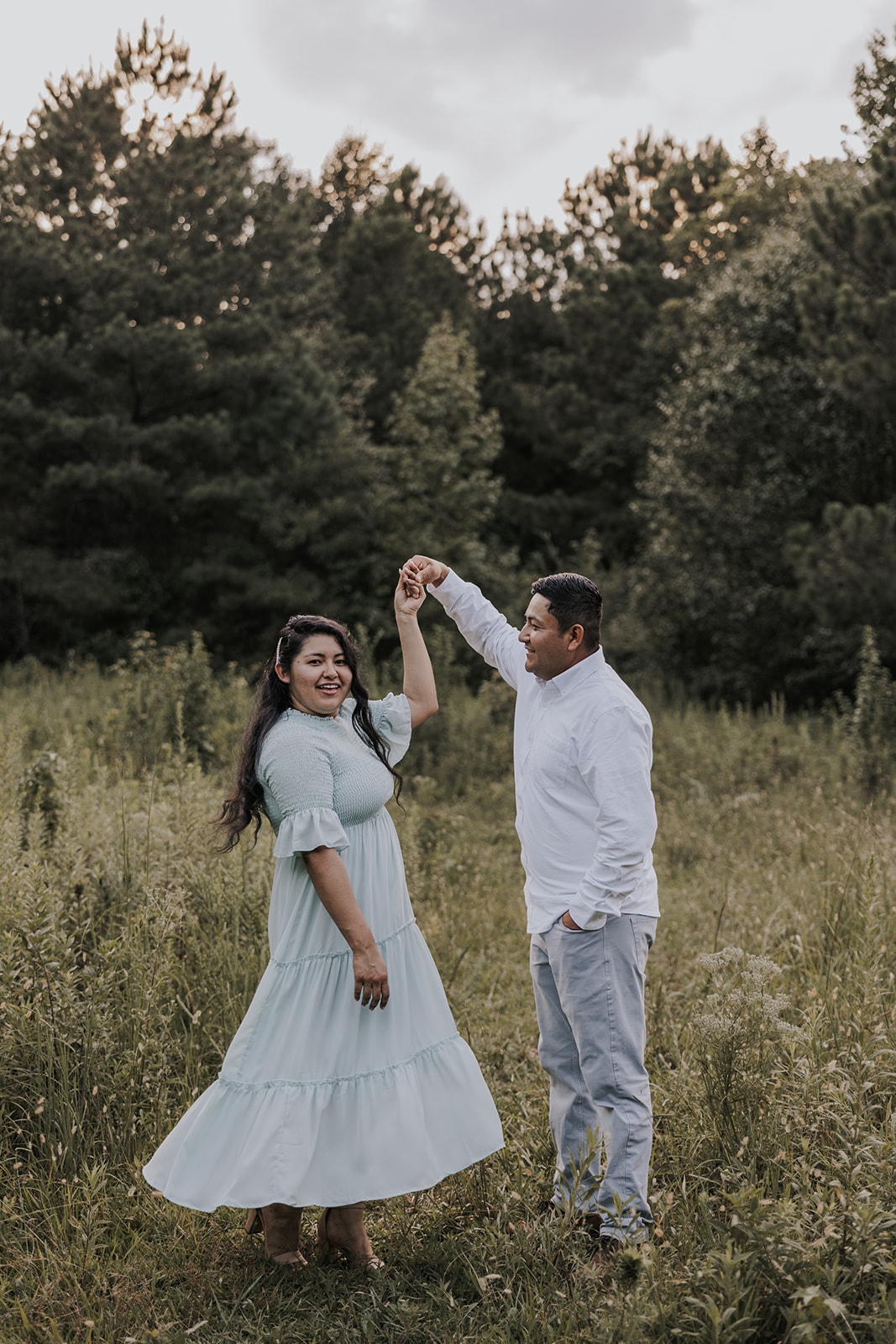 beautiful couple stands in a Georgia field together during their mini session