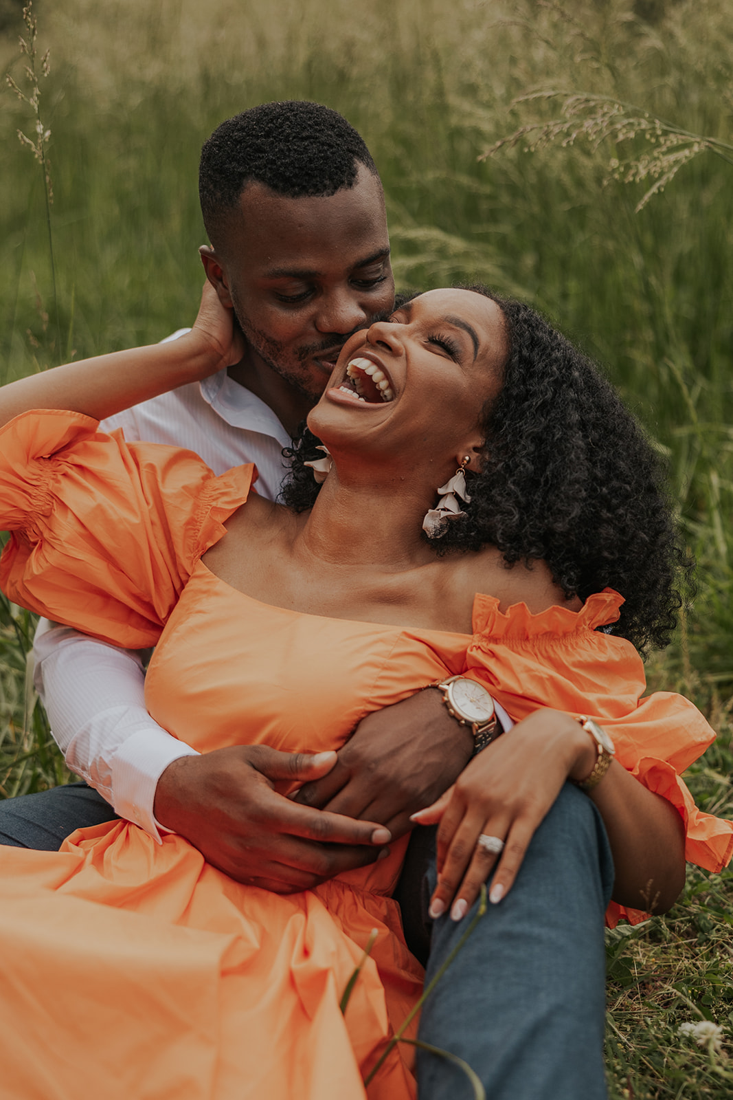 beautiful couple sits in a Georgia field together during their mini session