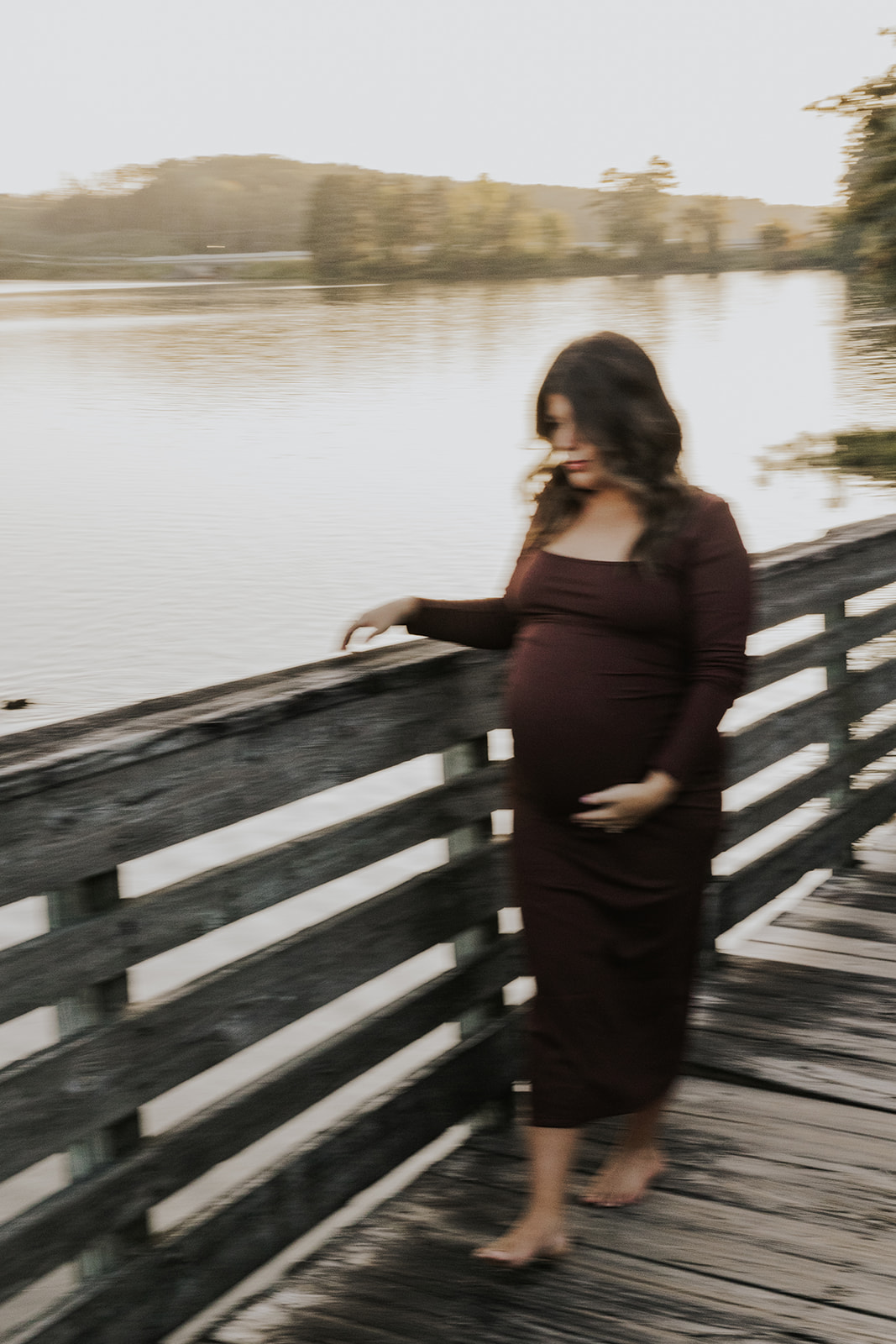 stunning future mom poses for a maternity photo lakeside