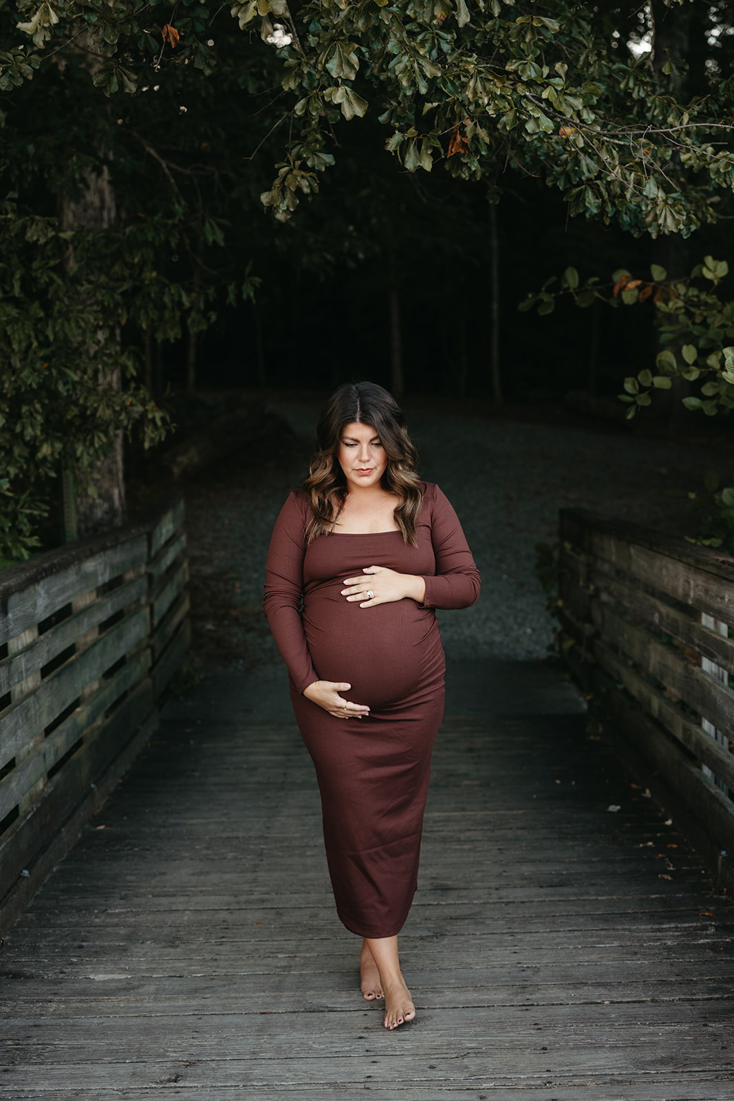 stunning future mom poses for a maternity photo lakeside