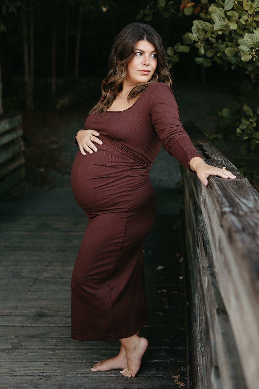 stunning future mom poses for a maternity photo lakeside