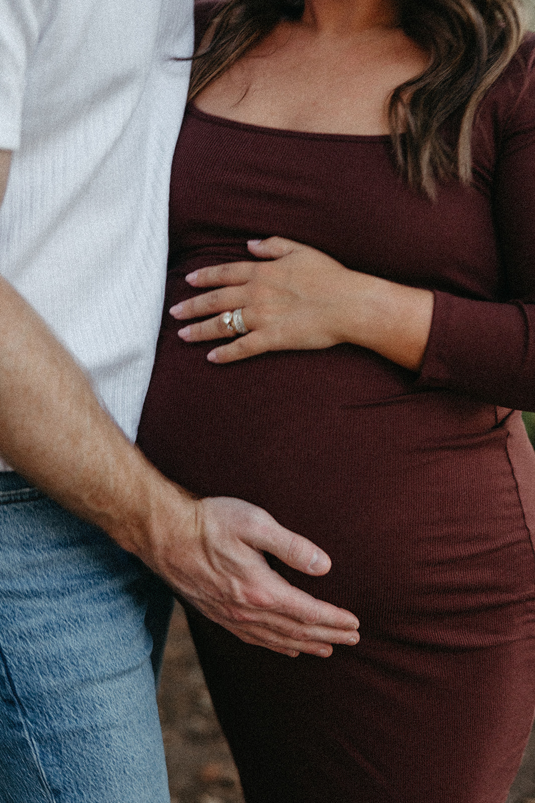 future parents pose together for a photo