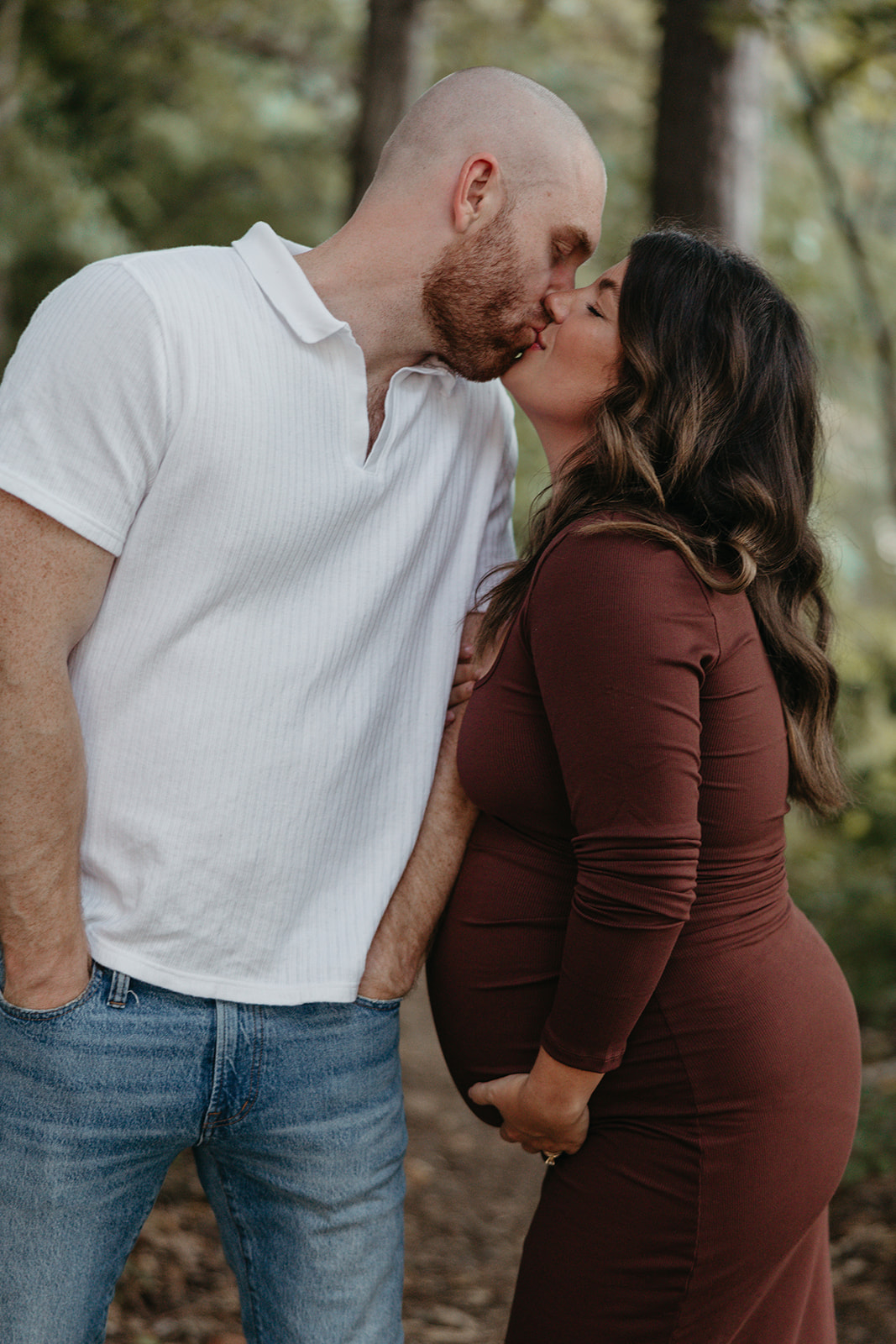 future parents pose together for a photo