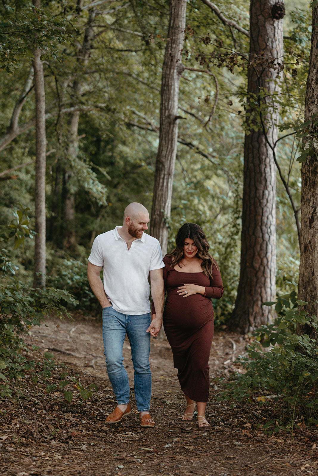 future parents pose together for a photo