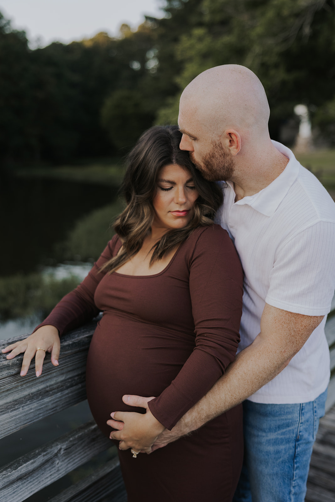 future parents pose together for a photo