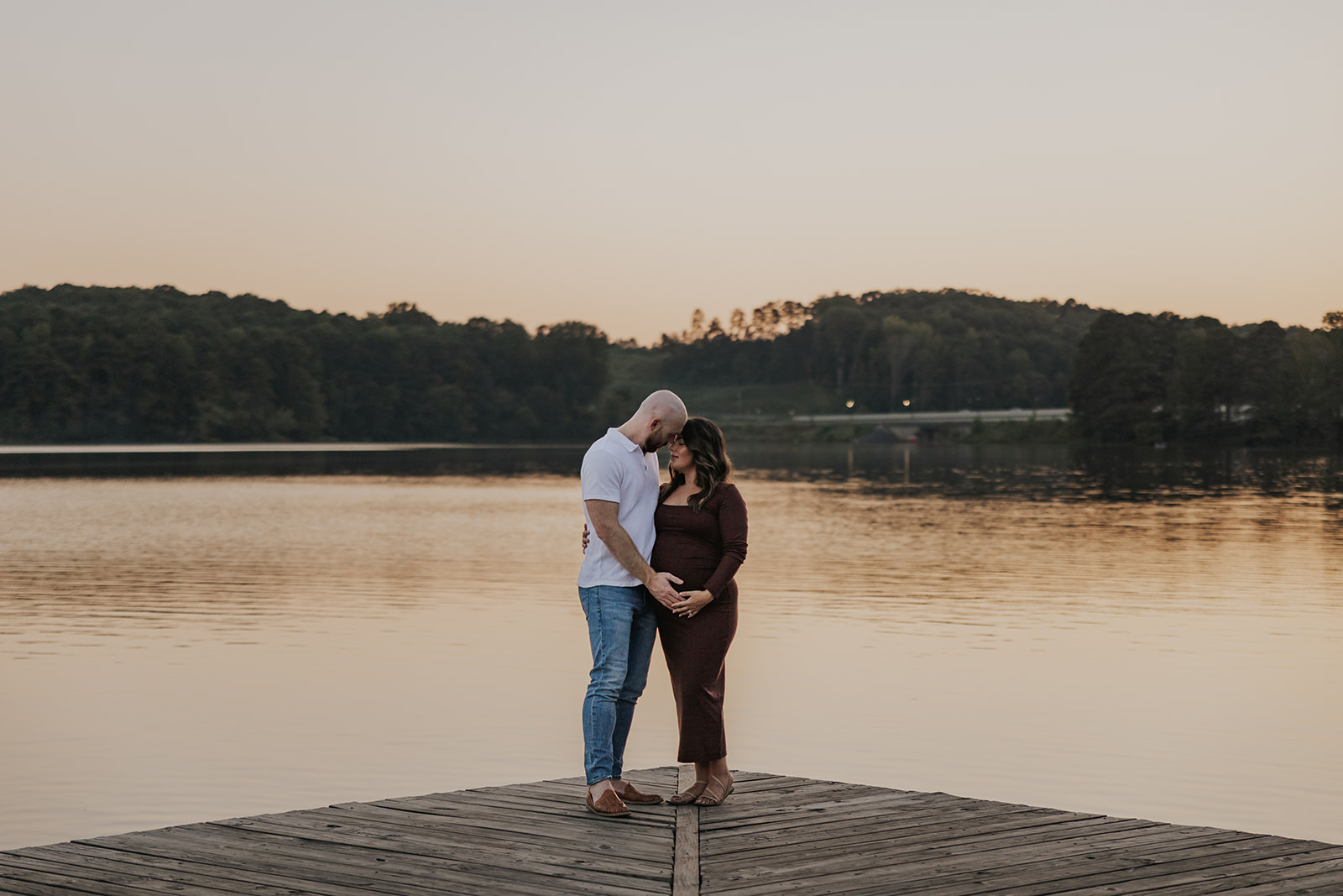 future parents pose together for a photo