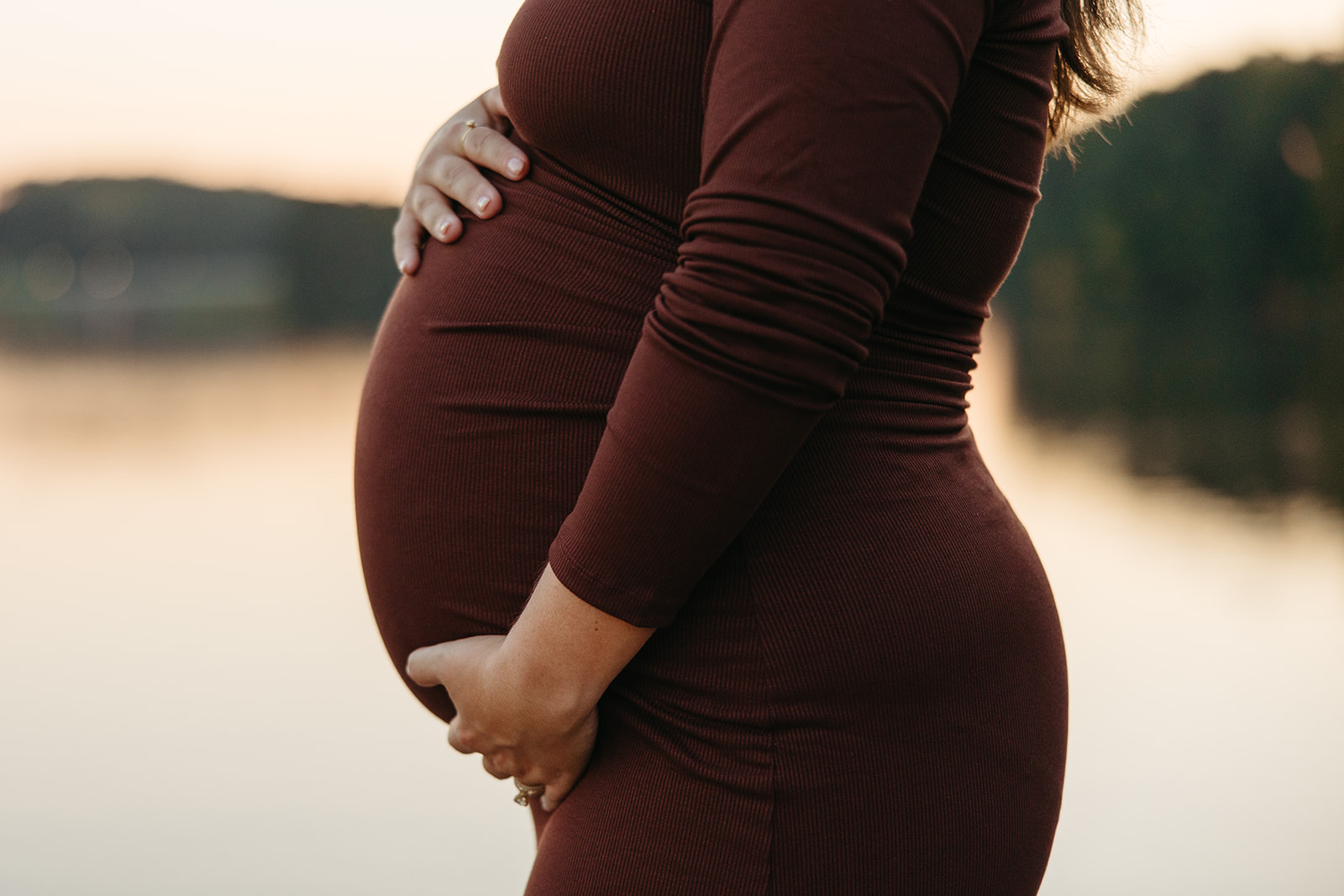 stunning future mom poses for a maternity photo lakeside