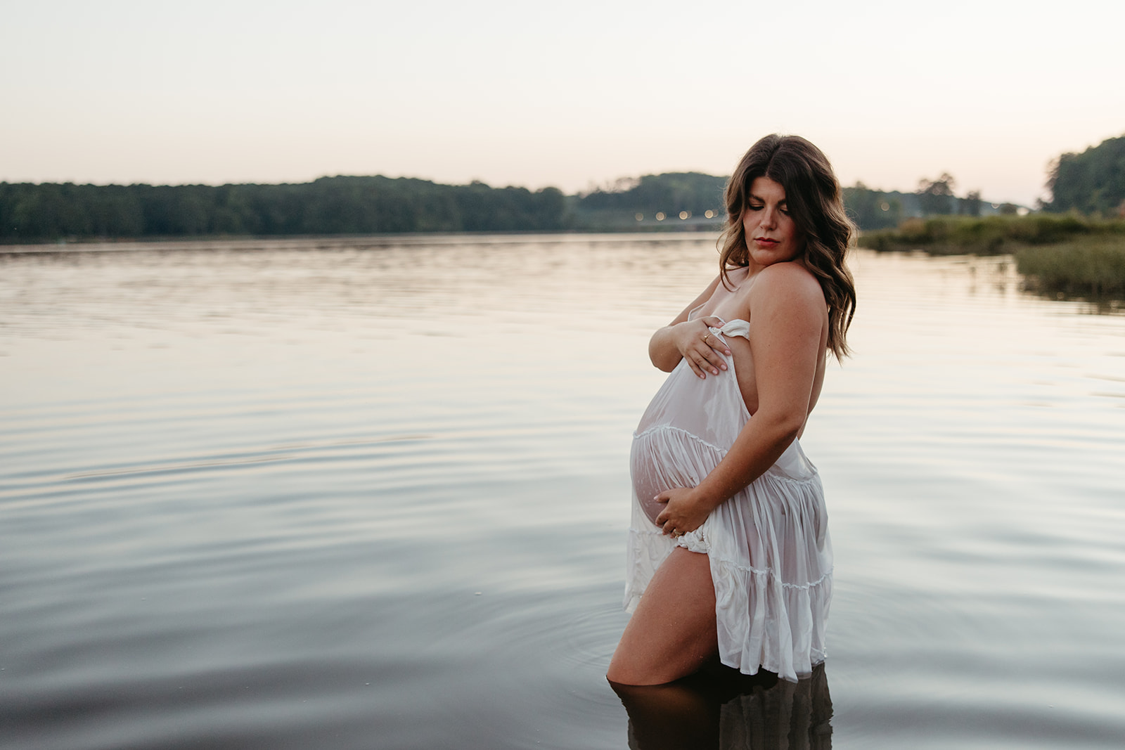 beautiful expecting mother poses for maternity photos in water