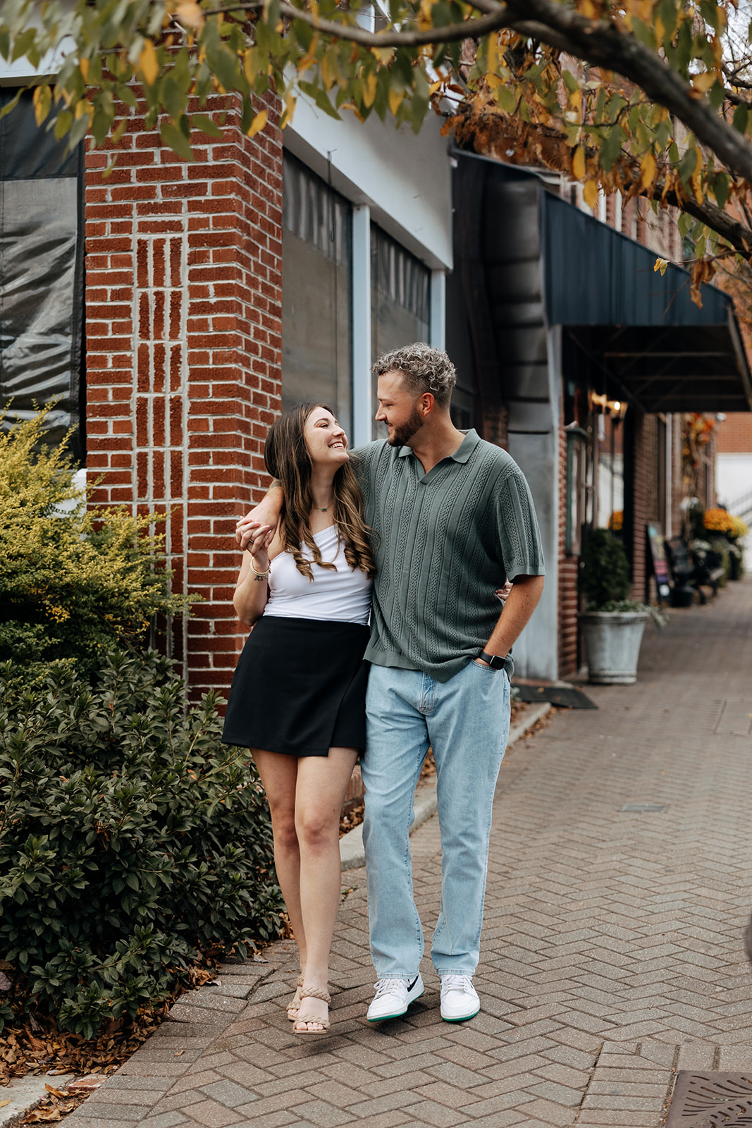 stunning couple pose together downtown of a small Georgia town during their engagement session