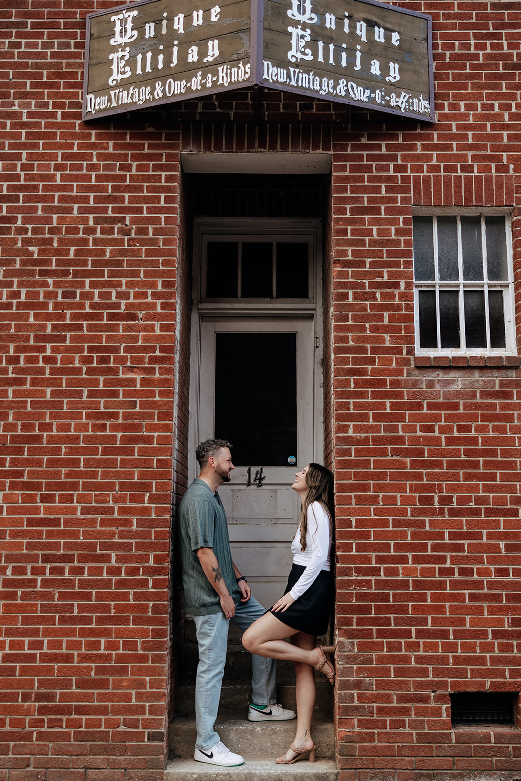 stunning couple pose together downtown of a small Georgia town during their engagement session