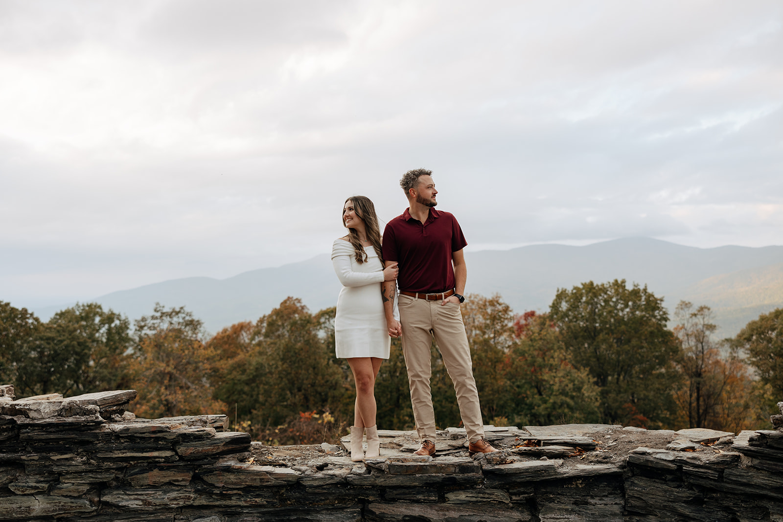 stunning couple pose with Arabia Mountain looming through the fog behind them