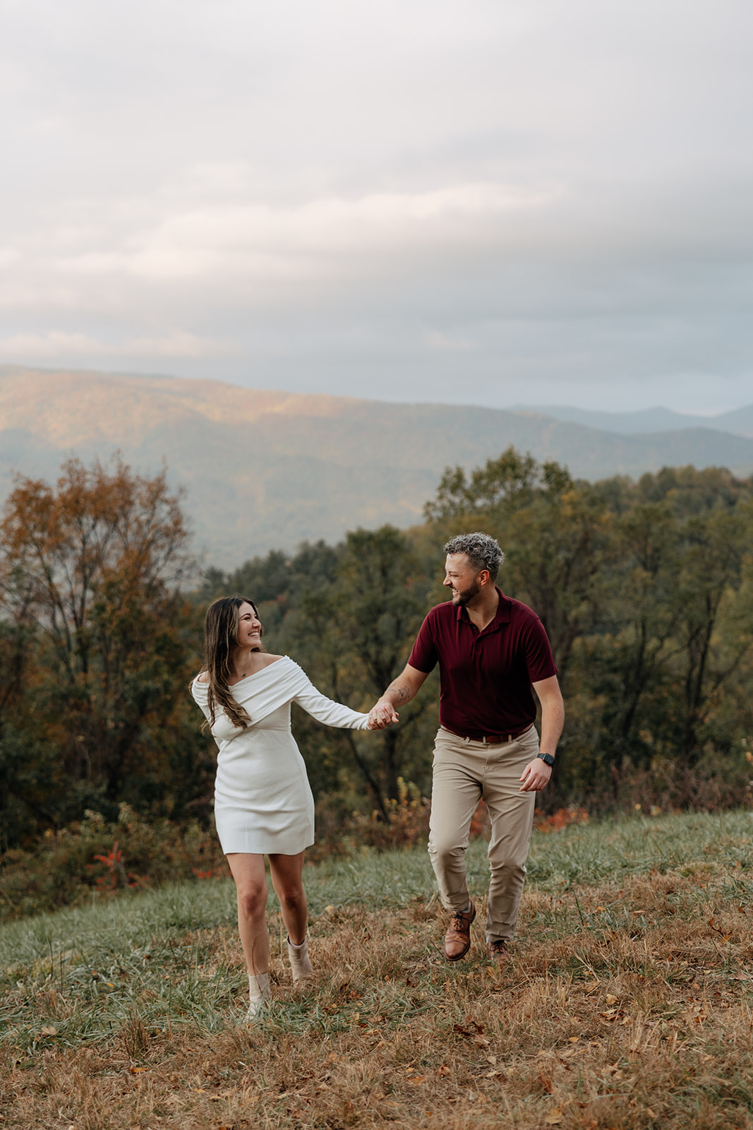 stunning couple pose with Arabia Mountain looming through the fog behind them