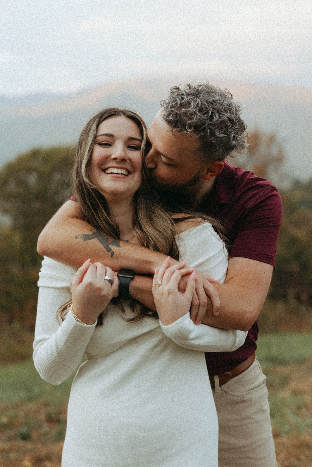 stunning couple pose with Arabia Mountain looming through the fog behind them