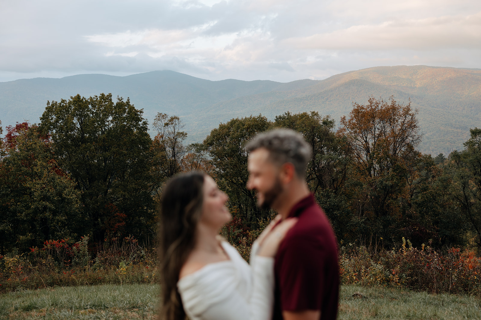 stunning couple pose with Arabia Mountain looming through the fog behind them